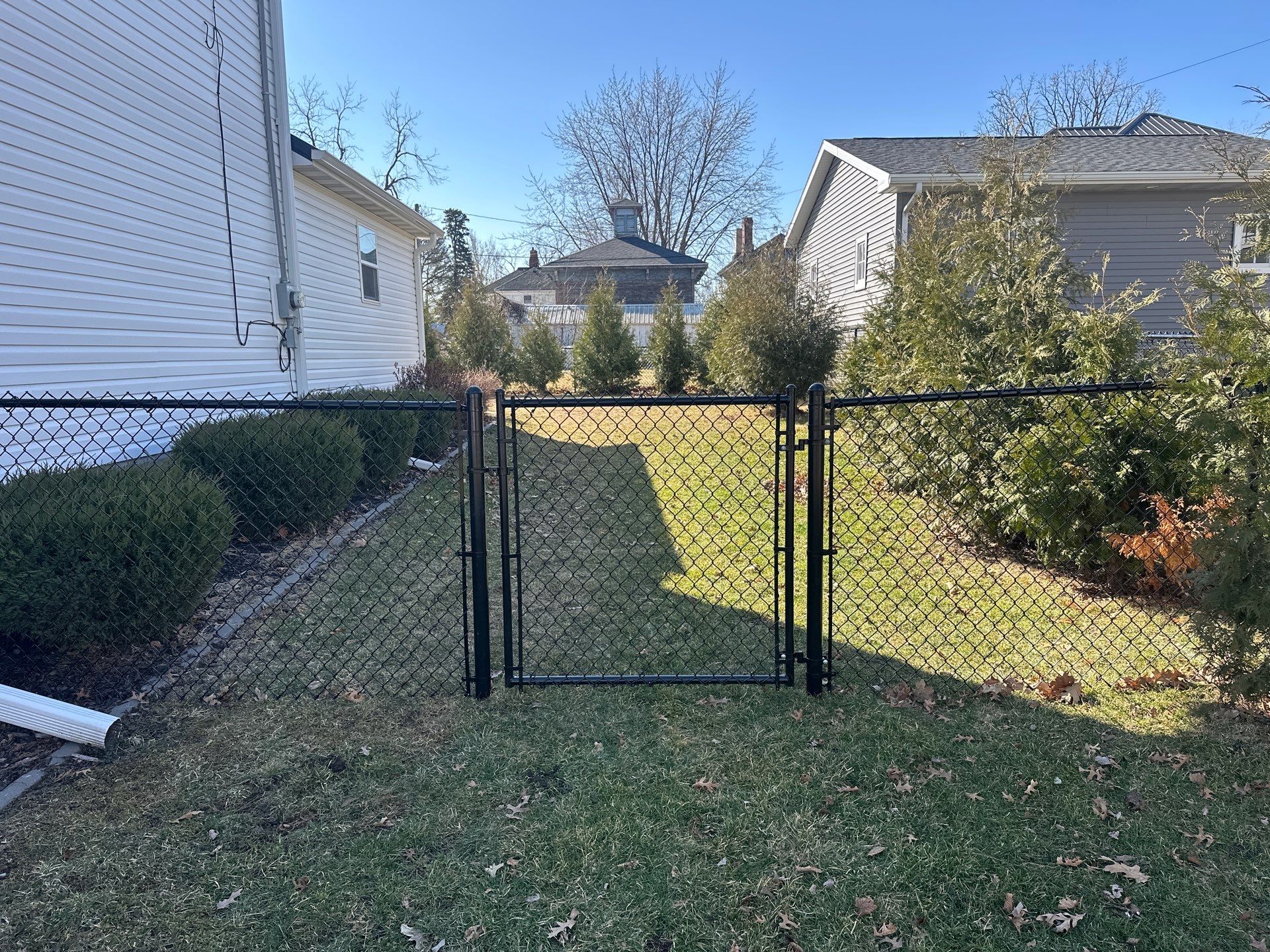 Black Chain Link Backyard Fence Installation in Independence by Perfect Picket Fence and Stain