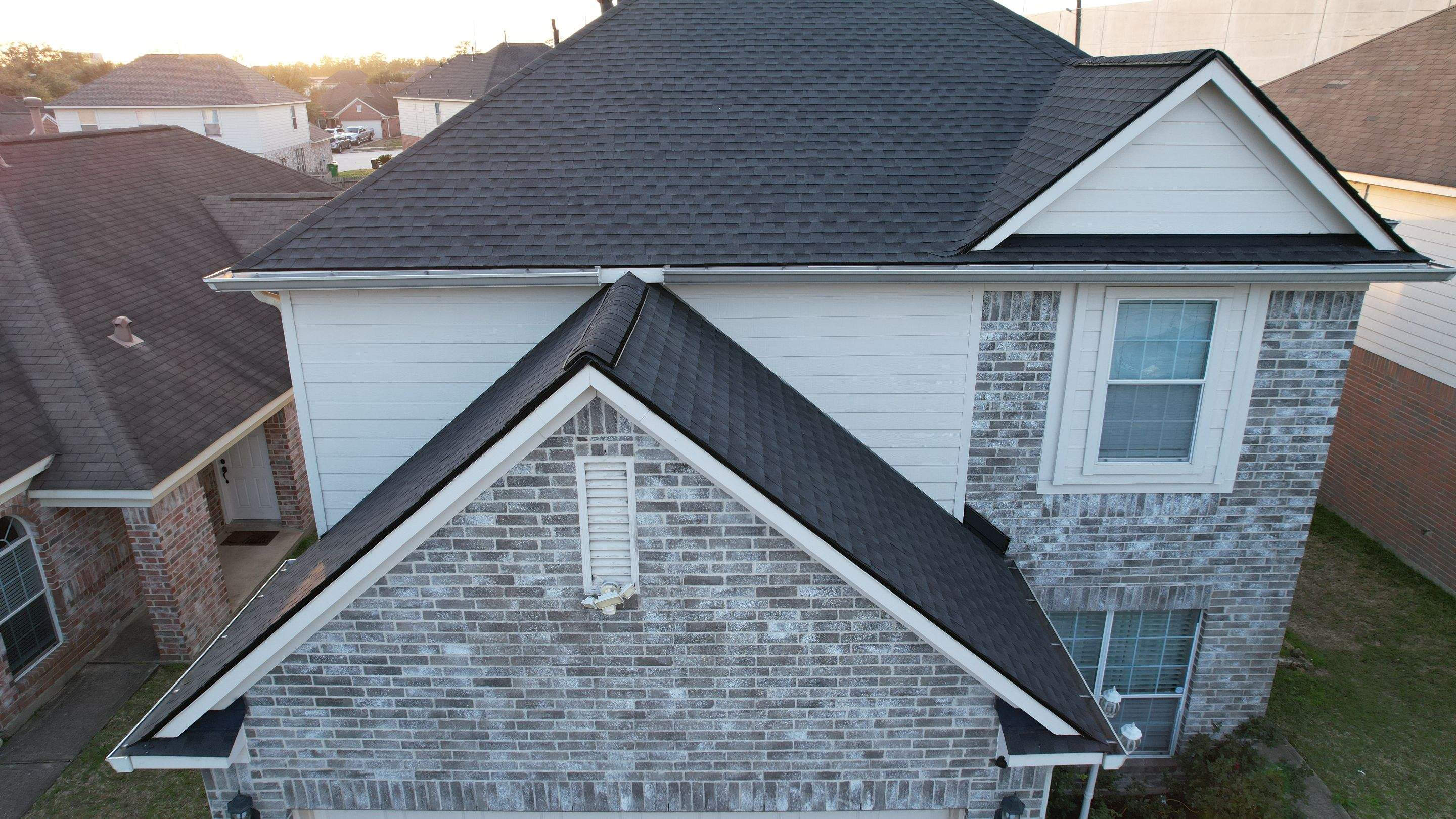 Slate-Gray Roof on Stone-Front Home — Spring, TX by PL Roofing & SB Roofing, LLC.