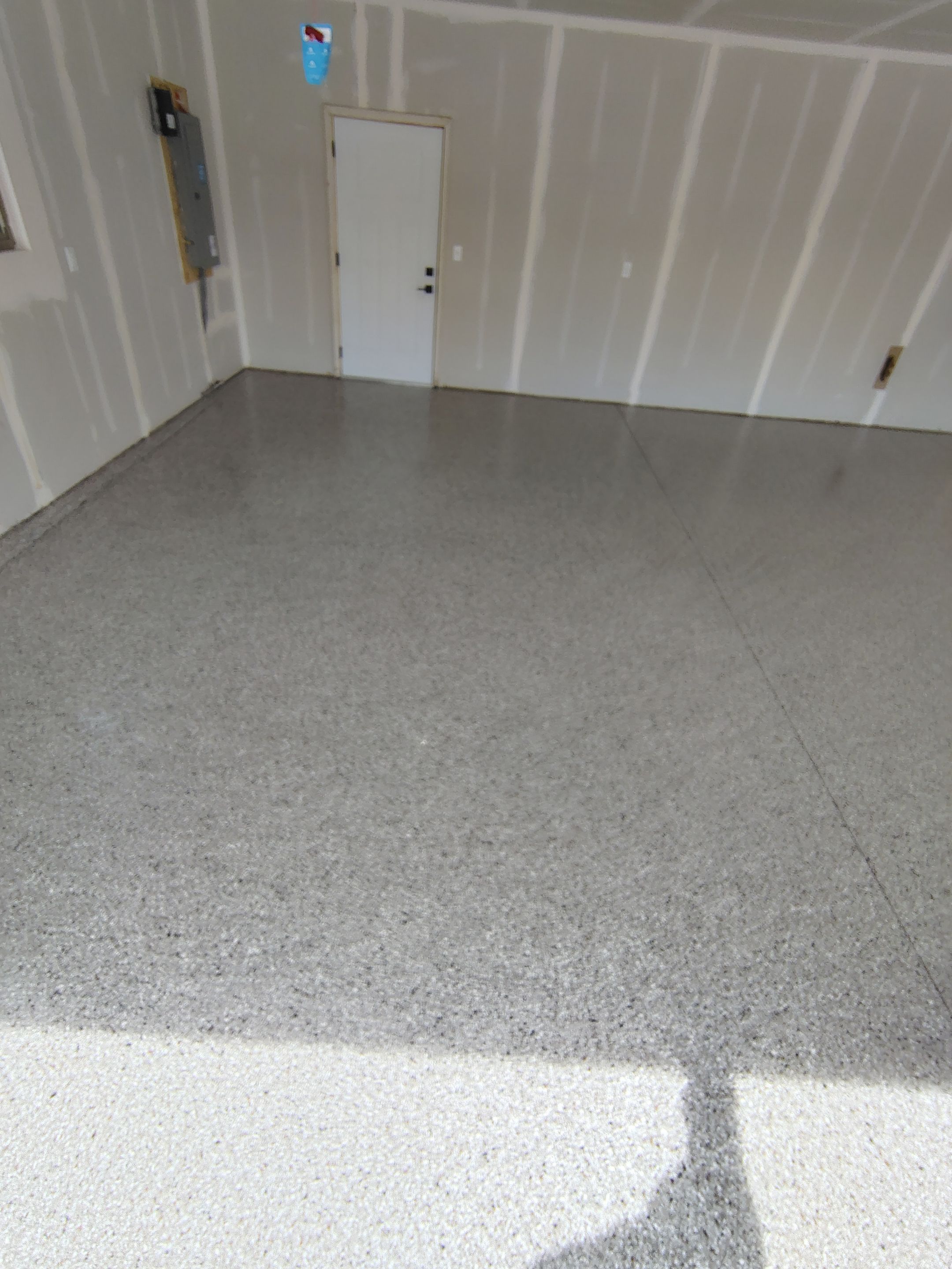Speckled Epoxy Garage Floor Coating Installation in Sioux Falls by Select Painting, Coatings & Garage Cabinets