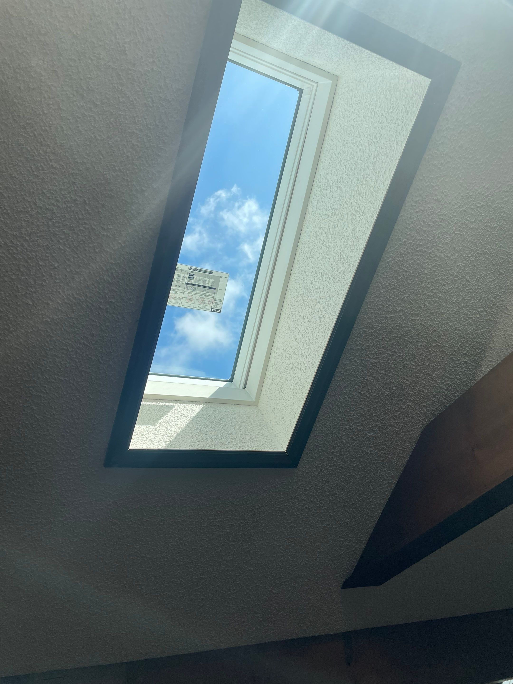 Shingle Roofing with Velux Skylight replacement and stone chimney flashing  by Secure Construction Company Inc