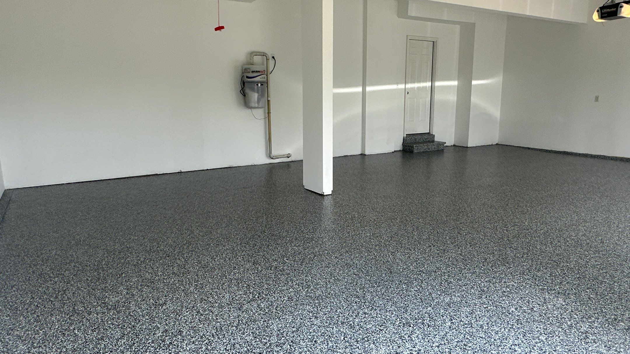 Laura B. garage transformation with a new floor and garage storage  by Banner Garage