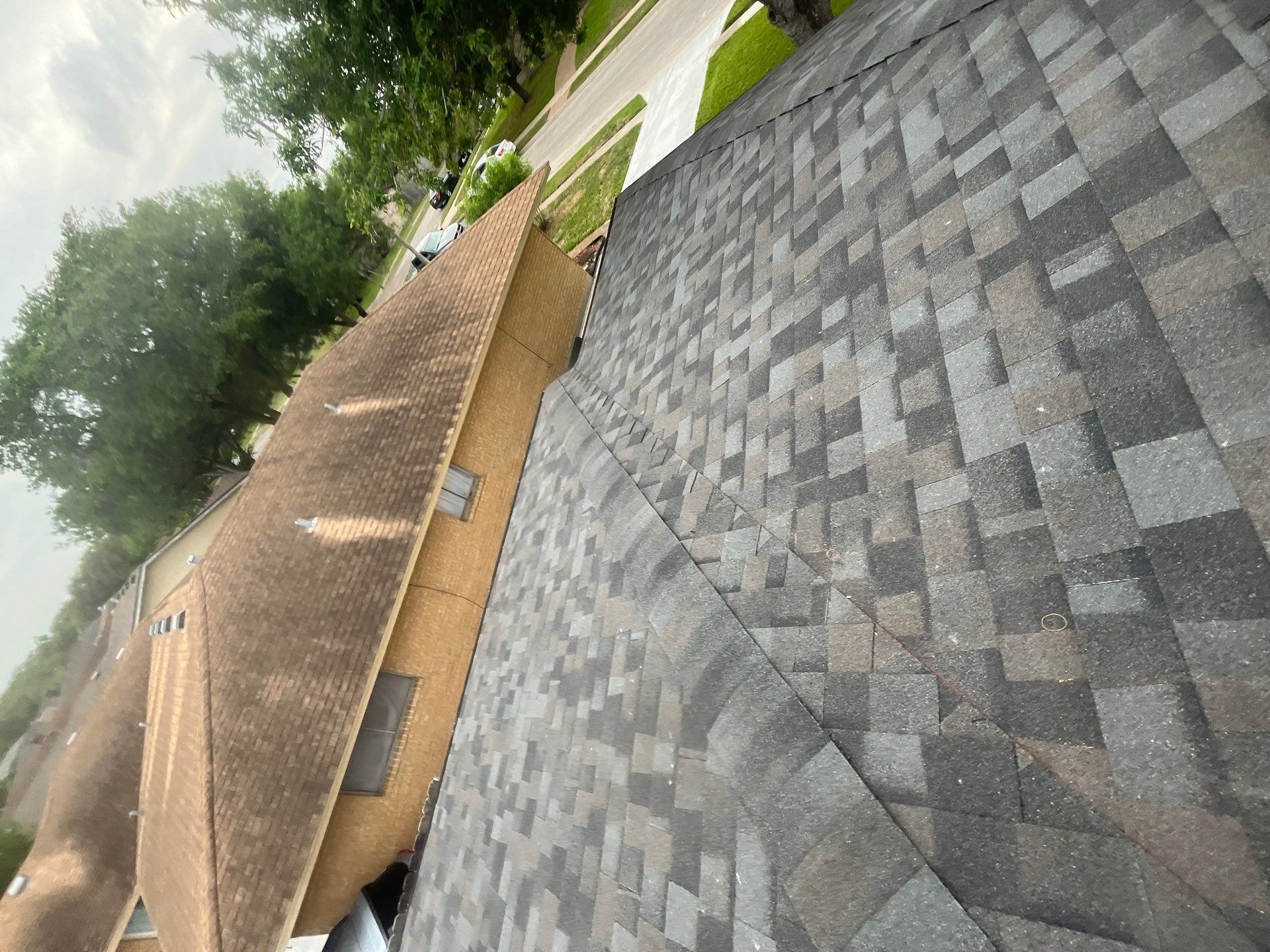 Colored Vinyl Windows to blend into brick by Bayfront Roofing and Construction