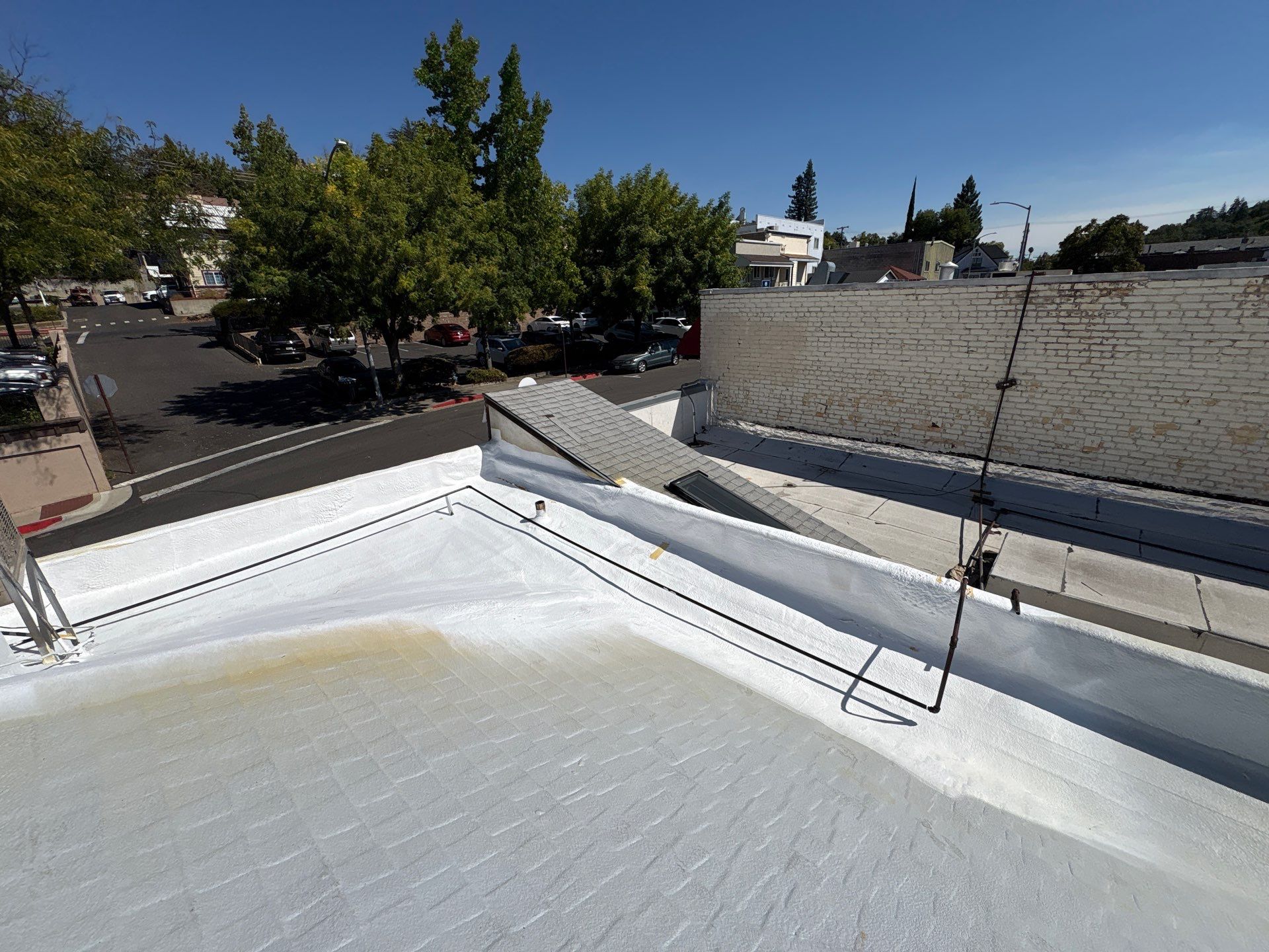 Foam and coatings on commercial roof by Straight Edge Roofing Inc