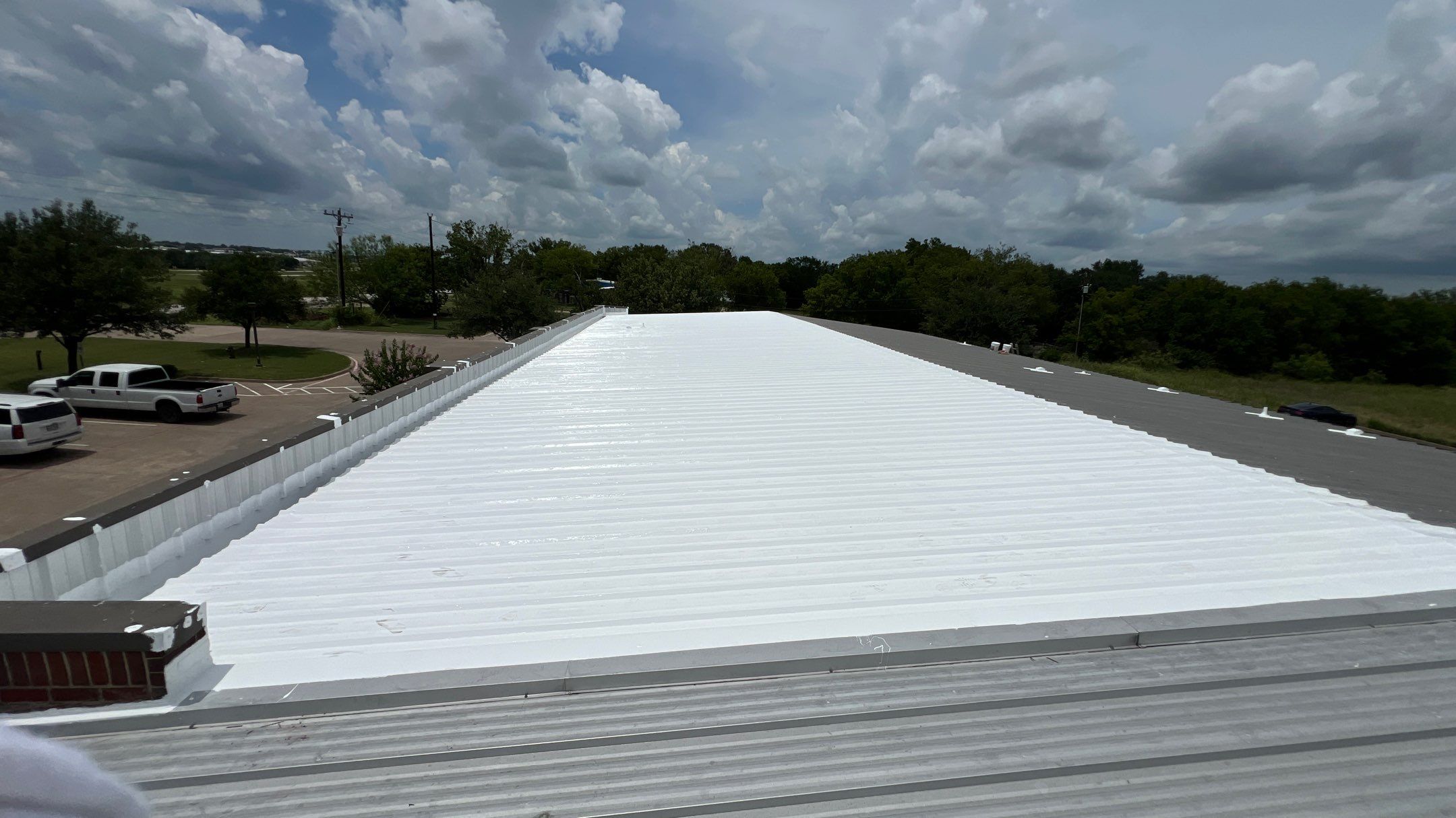 Commercial Roofing Installation using TRP #924 Eterna-Sil Premium Silicone Roof Coating by Harvey Roofing & Construction