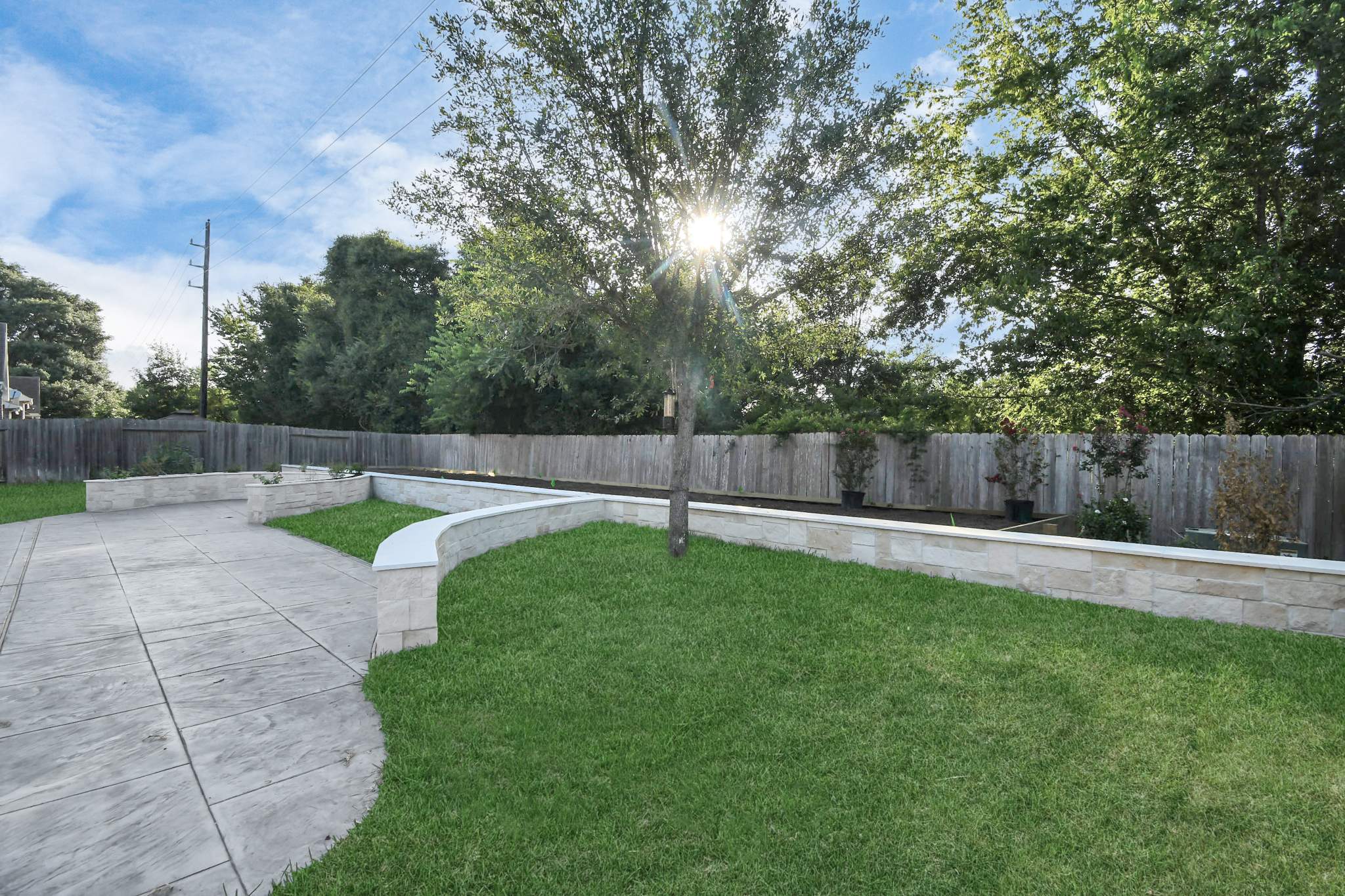 Major Transformation Project: Retaining Wall, Patio, and Drainage for Mr. & Mrs. Veerman! 🤩🛠️ We recently completed a comprehensive, custom project for Mr. & Mrs. Veerman that was all about structure, stability, and stunning outdoor design! This was a multi-phased project requiring the expertise of our Master Handcrafted Team.  Phase 1: Foundation and Water Management A successful outdoor space starts beneath the surface. We focused heavily on preparation and protection:  Demolition & Grading: We professionally removed and disposed of old dirt to achieve a level surface, ensuring the entire area was leveled and graded to enhance both appearance and functionality.  Comprehensive Drainage System: To prevent water issues and protect the new construction, we installed a complete system, connecting existing downspout gutters to channel drainage and strategically placed catch basins around the patio area.  Robust Concrete Foundation: Expert framing led to the pouring of a 4-inch deep, high PSI concrete slab to create a robust and lasting foundation for the entire retaining wall area.  Phase 2: Handcrafted Structure and Style This phase brought in our masonry and carpentry artisans to build the defining elements of the new space:  Custom Retaining Wall: Our master handcrafted team built a stunning, structural retaining wall. This involved careful framing, precise concrete work, and meticulous masonry construction with vertical supports every 3 feet for maximum stability.  Client Involvement: Mr. & Mrs. Veerman played a key role in selecting the retainer wall fascia and stone materials, ensuring the final look perfectly matched their vision.  Stamped Concrete Patio: We installed a beautiful stamped concrete patio. This decorative concrete work involved imprinting a pattern into the fresh concrete, giving them the high-end look of stone or brick with the durability of concrete.  Walk Add-On: Extended the stamped concrete to include a new, seamless walk area.  (Optional) Custom Garden Box: Constructed durable, raised garden boxes using 2"x12" boards and strong 4"x6" posts.  Phase 3: Landscaping and Finishing Touches The final details bring the entire project to life, focusing on irrigation and planting:  Sprinkler System Upgrade: To support their new landscaping, we upgraded their irrigation system by installing two new drip zones and a new control unit.  Flower Beds: Integrated new flower beds along the retaining wall and patio, ready for planting.  Decoration: Concluded the project with personalized decoration options to perfectly complement their beautiful, newly structured space.  Thinking About a Multi-Layered Outdoor Project? This project demonstrates our ability to seamlessly handle complex jobs—from heavy-duty drainage and structural construction to decorative finishes and irrigation.  The proposed timeline for this extensive project was 10 to 15 working days!  ❓ Do you have a sloping yard or drainage issues that could be solved with a functional and beautiful retaining wall? Tell us your challenge! 👇  💡 We specialize in bringing intricate outdoor visions to life! If you're looking for a team with master craftsmen for your next patio, retaining wall, or full landscape overhaul, let's talk. by Texas Urban Elements