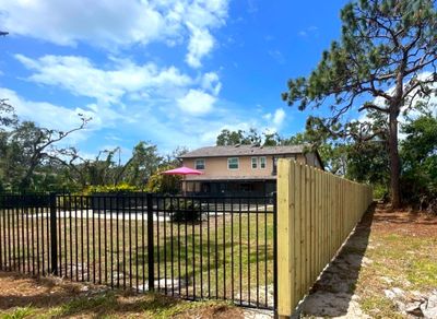 Black Aluminum 3 Rail Fence and Treated Wood Board on Board Privacy Fence 