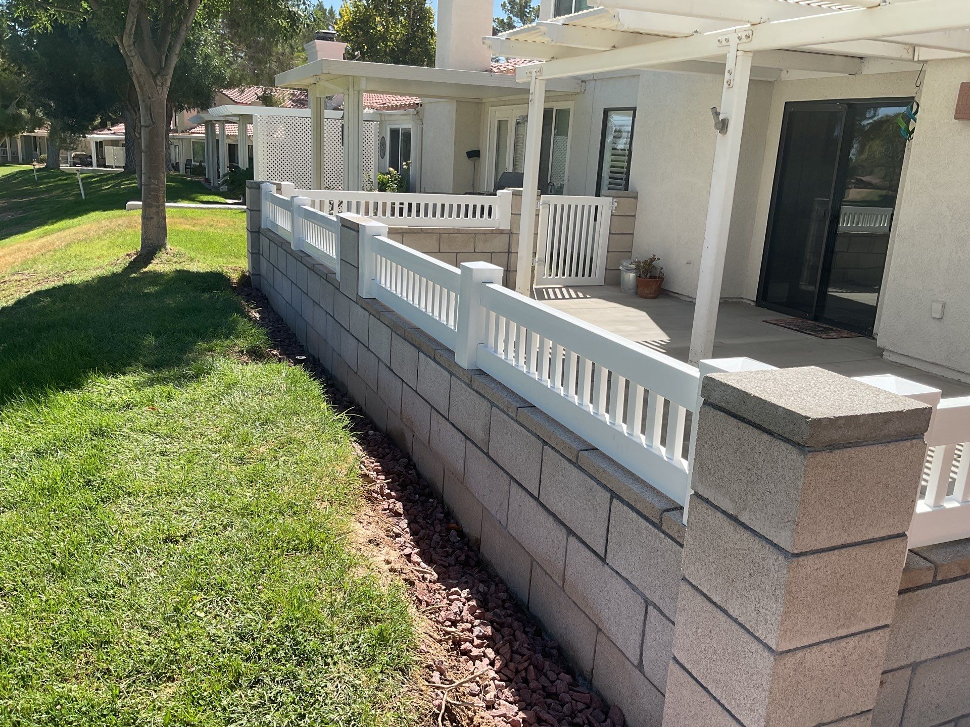 White Box Picket Fence on top of block wall  by Fence Guys Inc. 