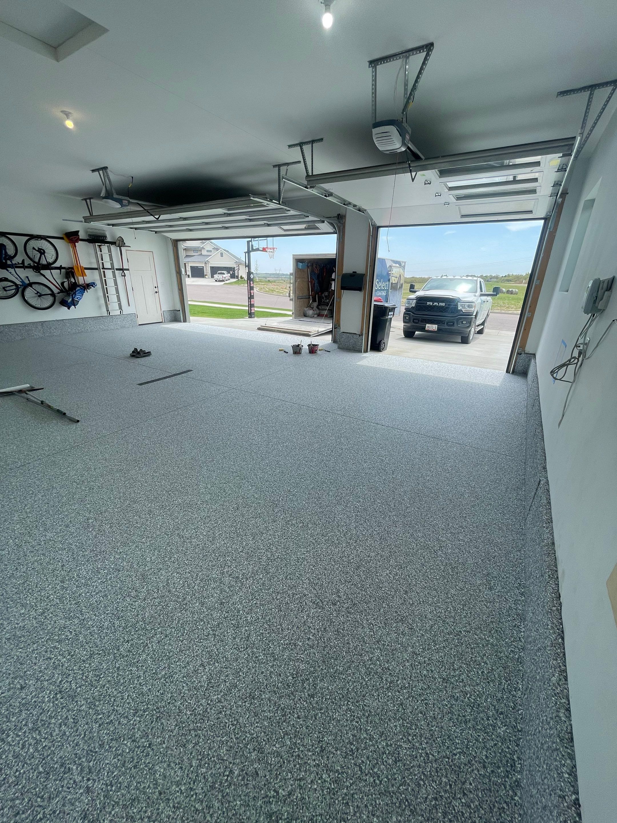 Full Garage Concrete Coating with Grey Speckled Epoxy in Brandon by Select Painting, Coatings & Garage Cabinets