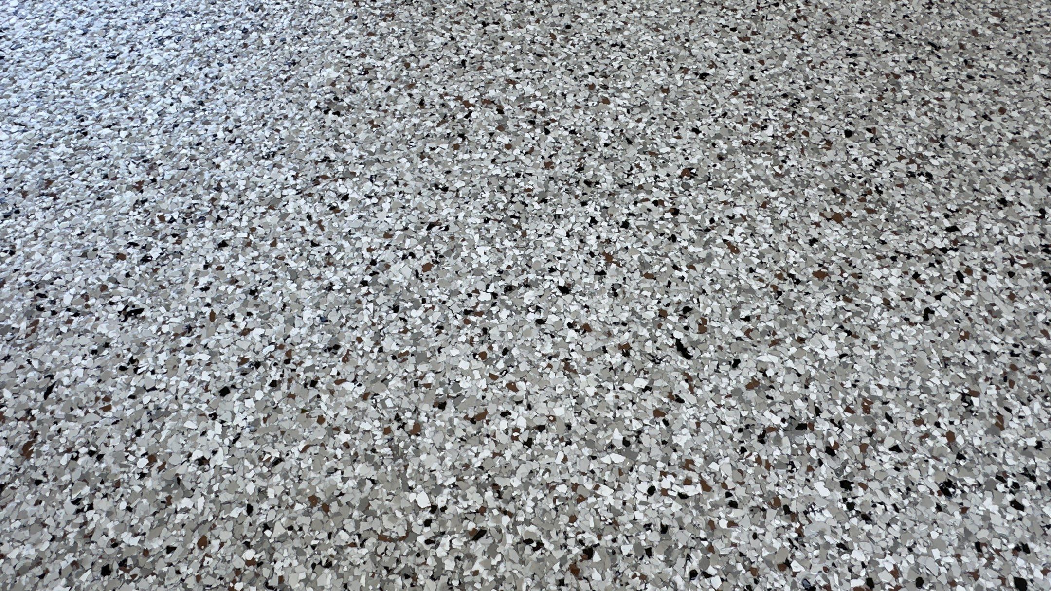 Look at this beautiful Coyote flake floor on this patio by Banner Garage