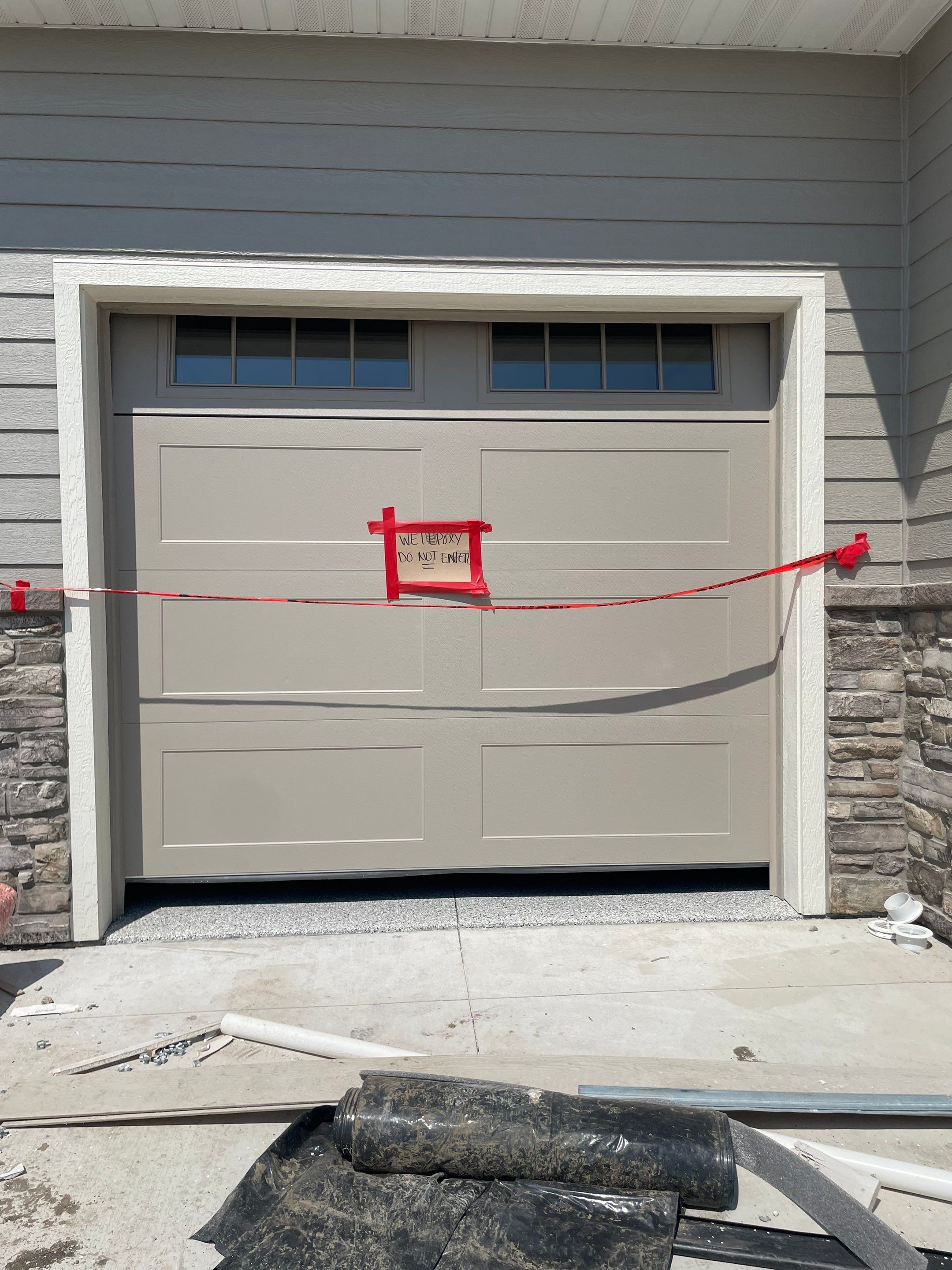 Grey Speckled Garage Floor Coating in Sioux Falls by Select Painting, Coatings & Garage Cabinets