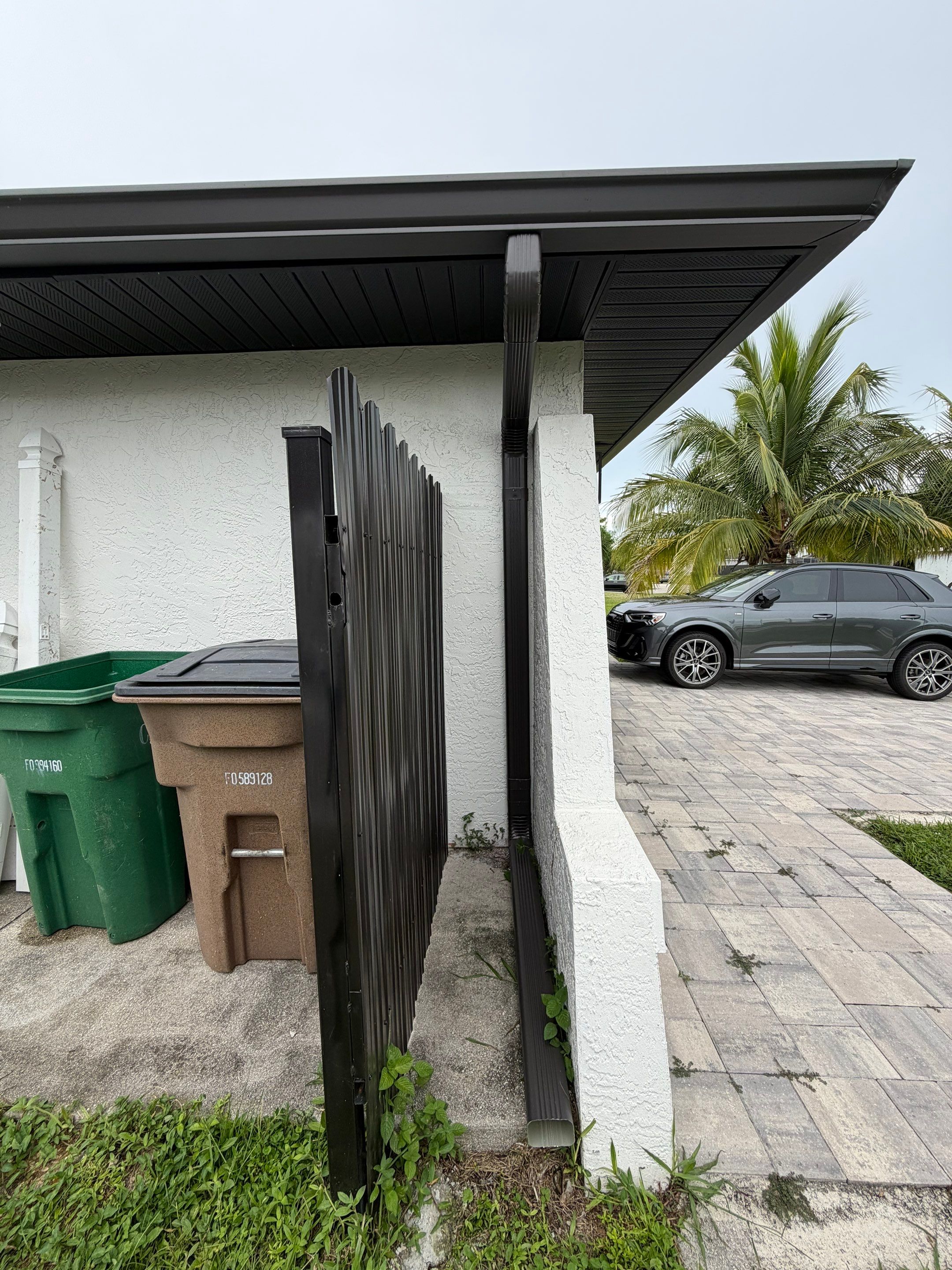 Black Seamless Gutters for a Modern Look in Cape Coral FL by Gutter Professors