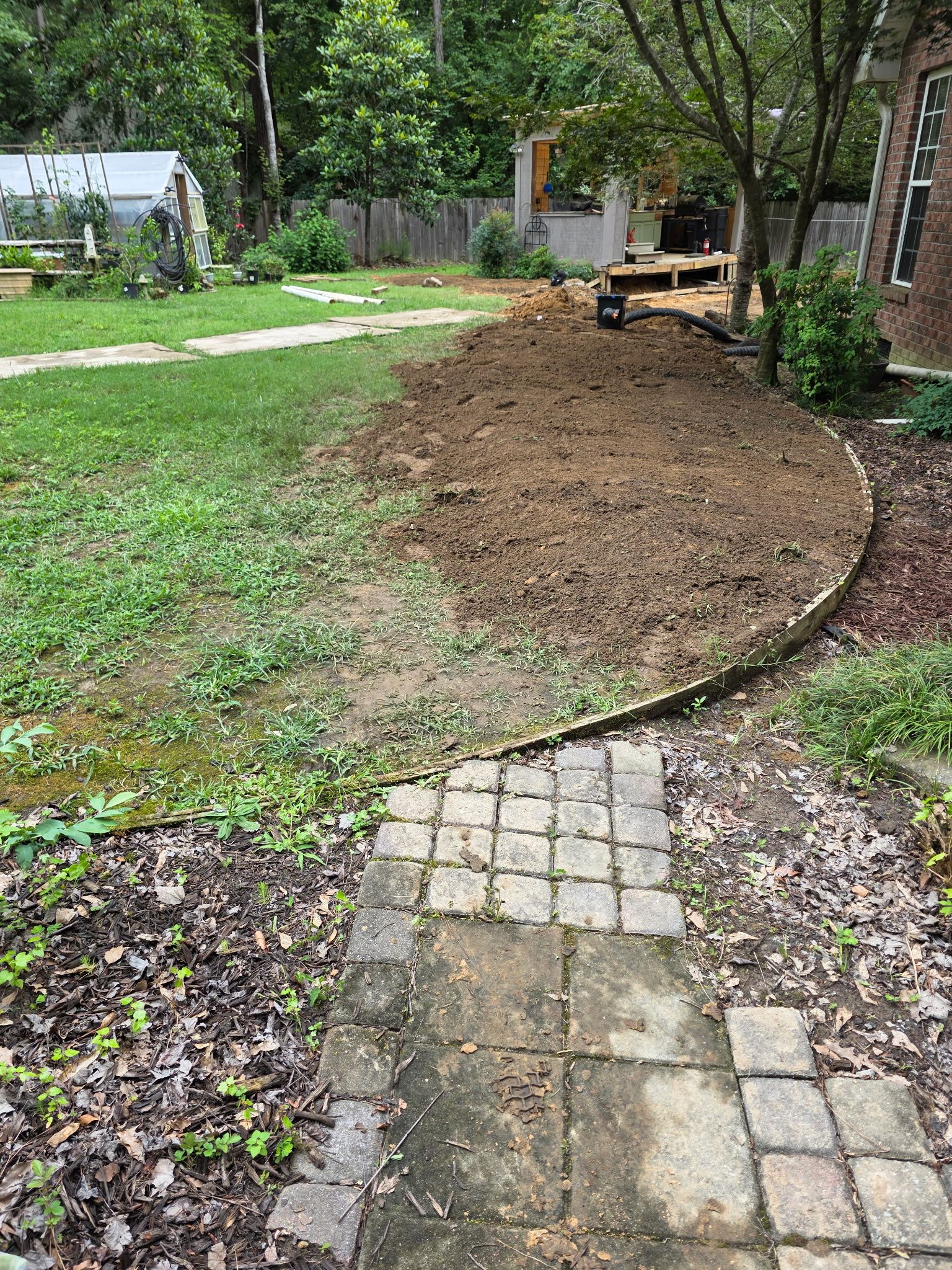 Patio in concrete with drainage improvements by Cornerstone Home Builders, LLC