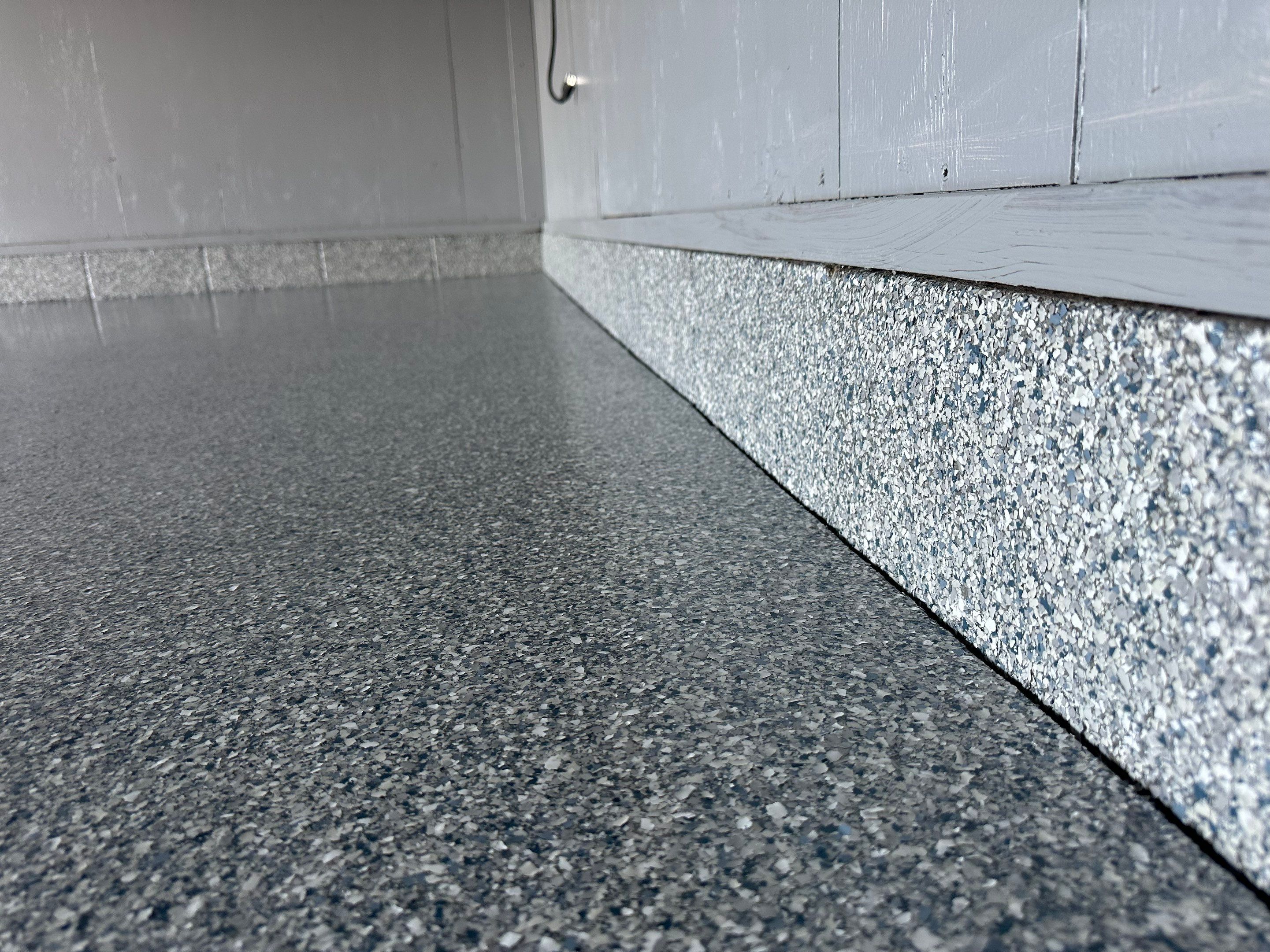 Multi-Colored Speckled Concrete Floor Coating Installation in Sioux Falls by Select Painting, Coatings & Garage Cabinets