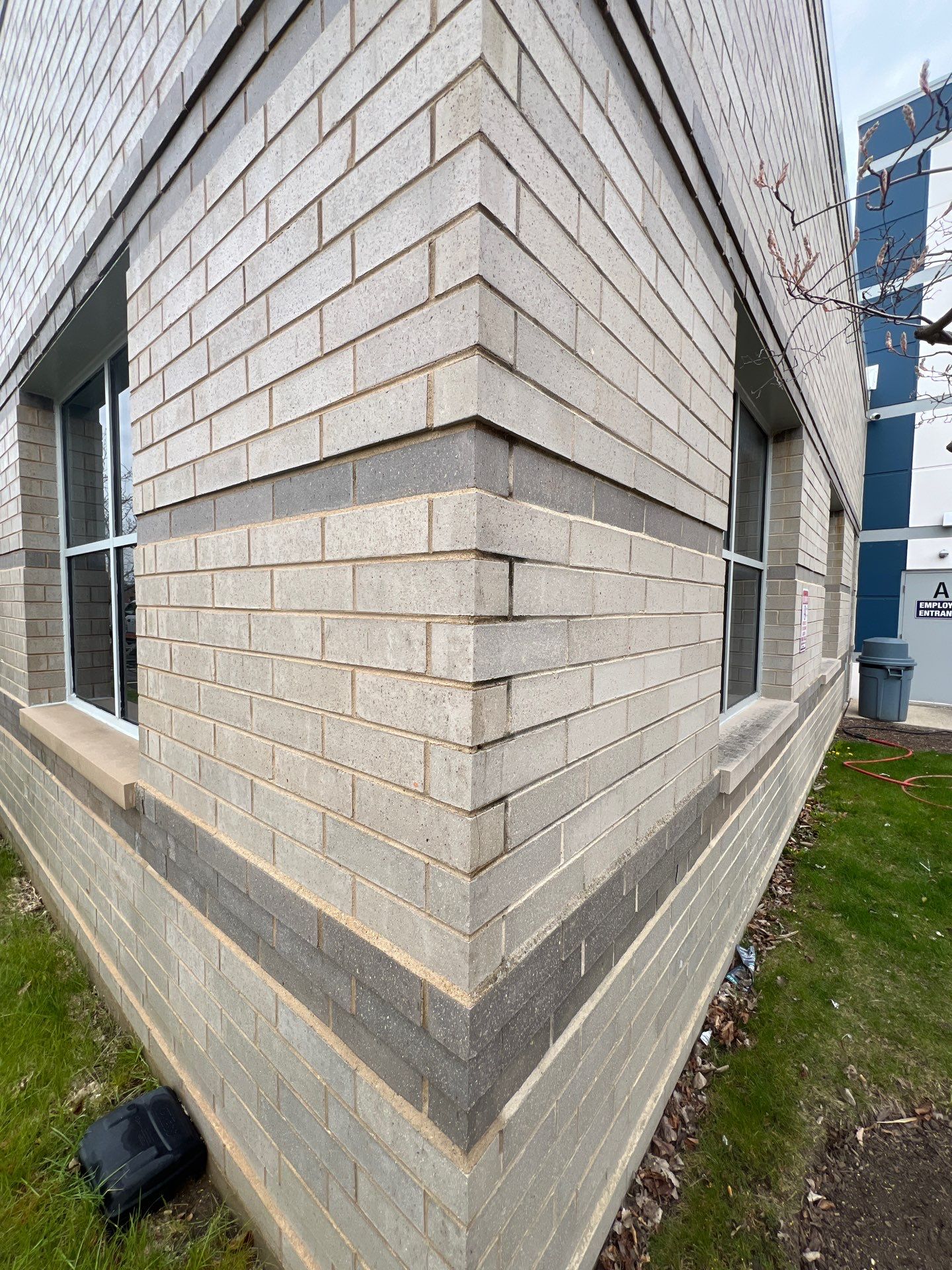 Commercial Facade cleaning using Algaecide, soft wash soap by Northern Power Washing LLC.