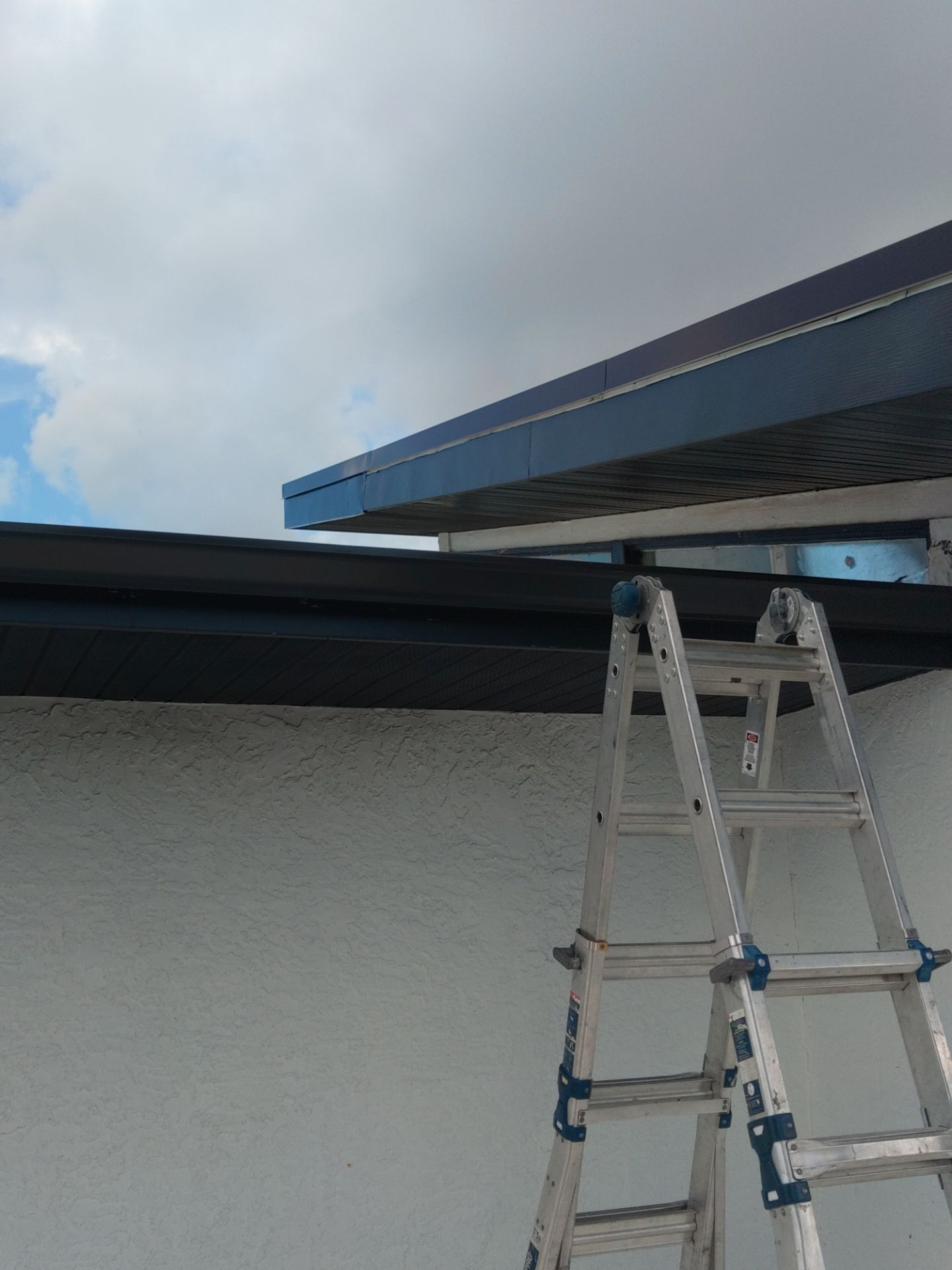 Black Seamless Gutters and Downspouts in Siesta Key FL by Gutter Professors