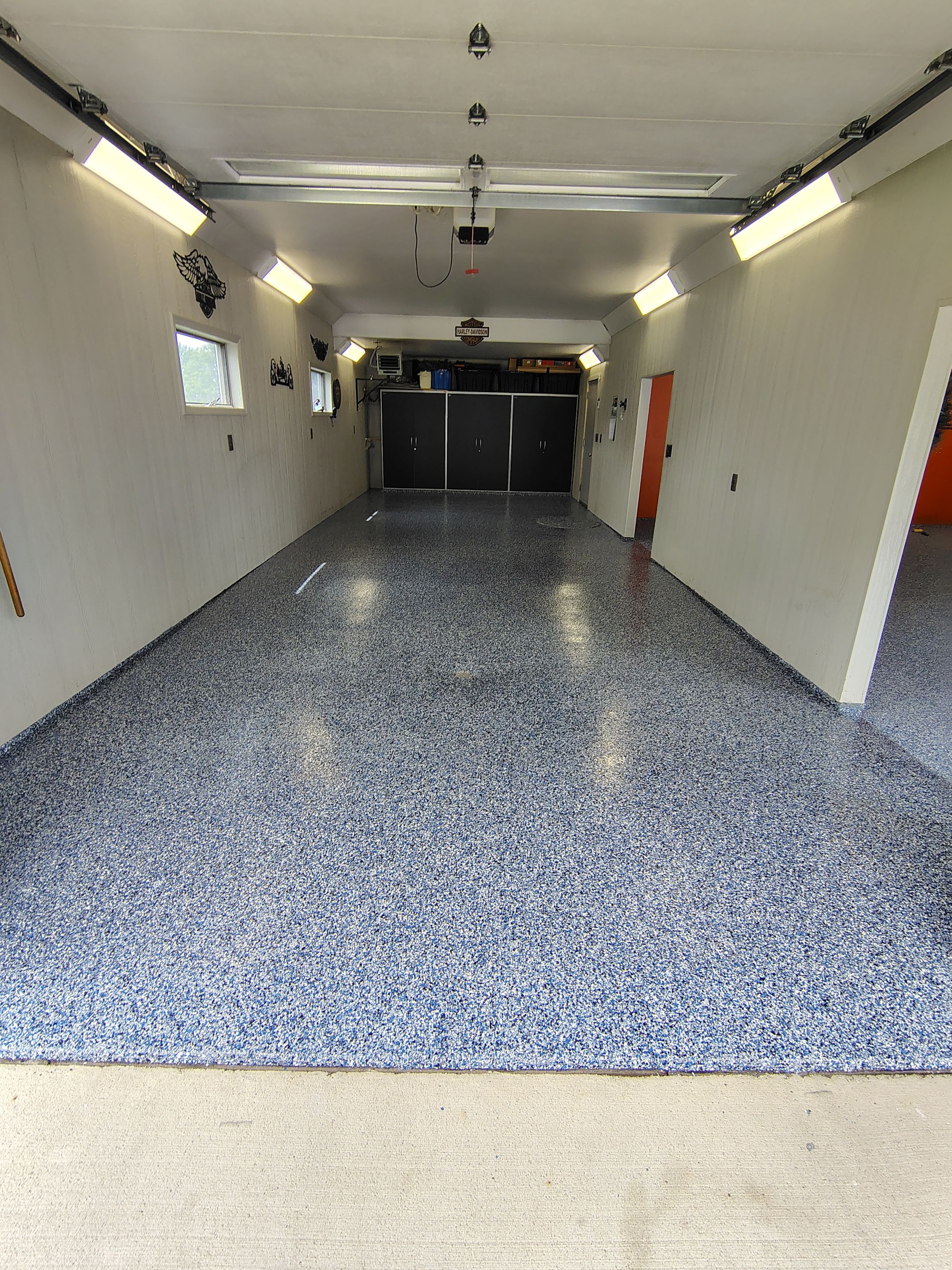 Custom Grey Flake Epoxy Garage Floor Installation in Remsen by Select Painting, Coatings & Garage Cabinets
