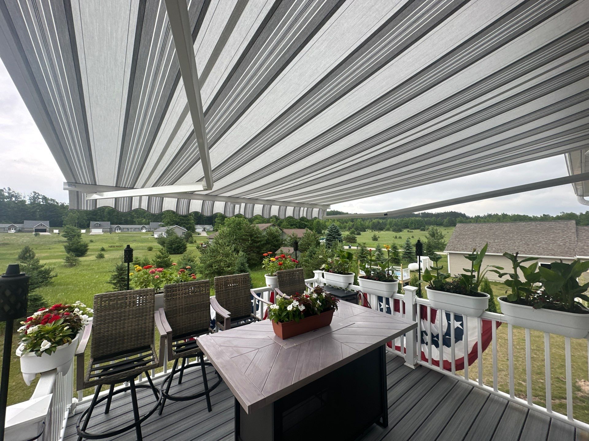 Sunesta Retractable Awning Installation Over Petoskey Home Deck by Rainbow Seamless Systems