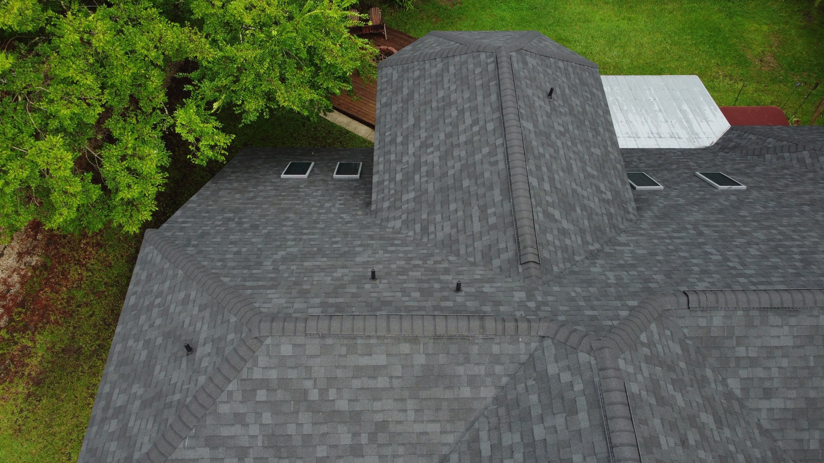 Complete Onyx Black Asphalt Shingle Roof Replacement and Skylight Installation in Jacksonville by Trinity Restoration and Roofing LLC