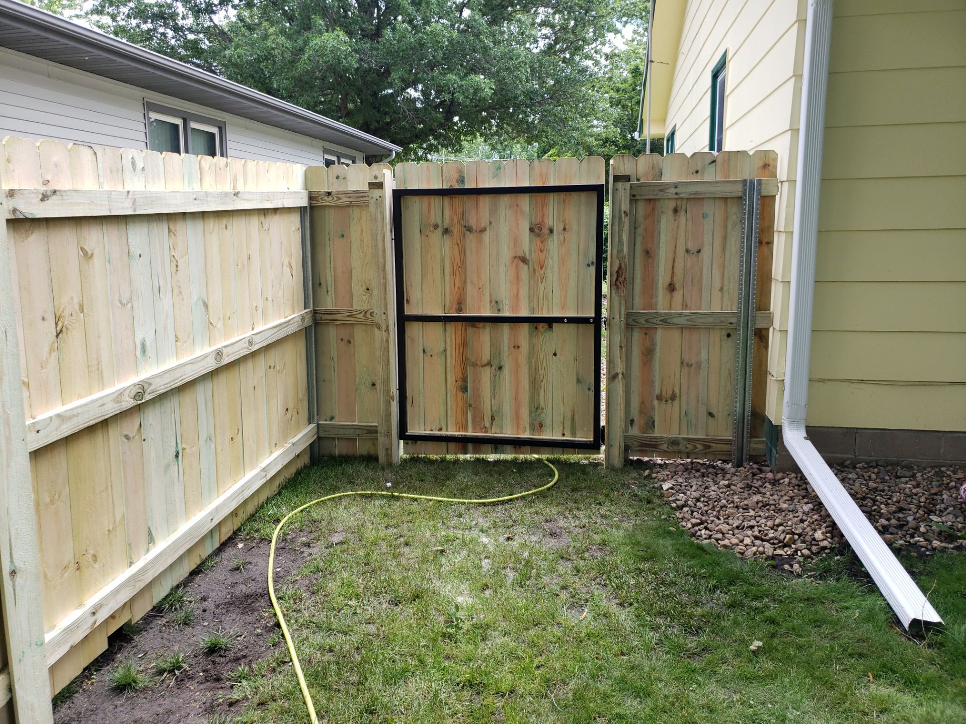 Custom Wood Privacy Fence Installation for Charles City Backyard by Perfect Picket Fence and Stain