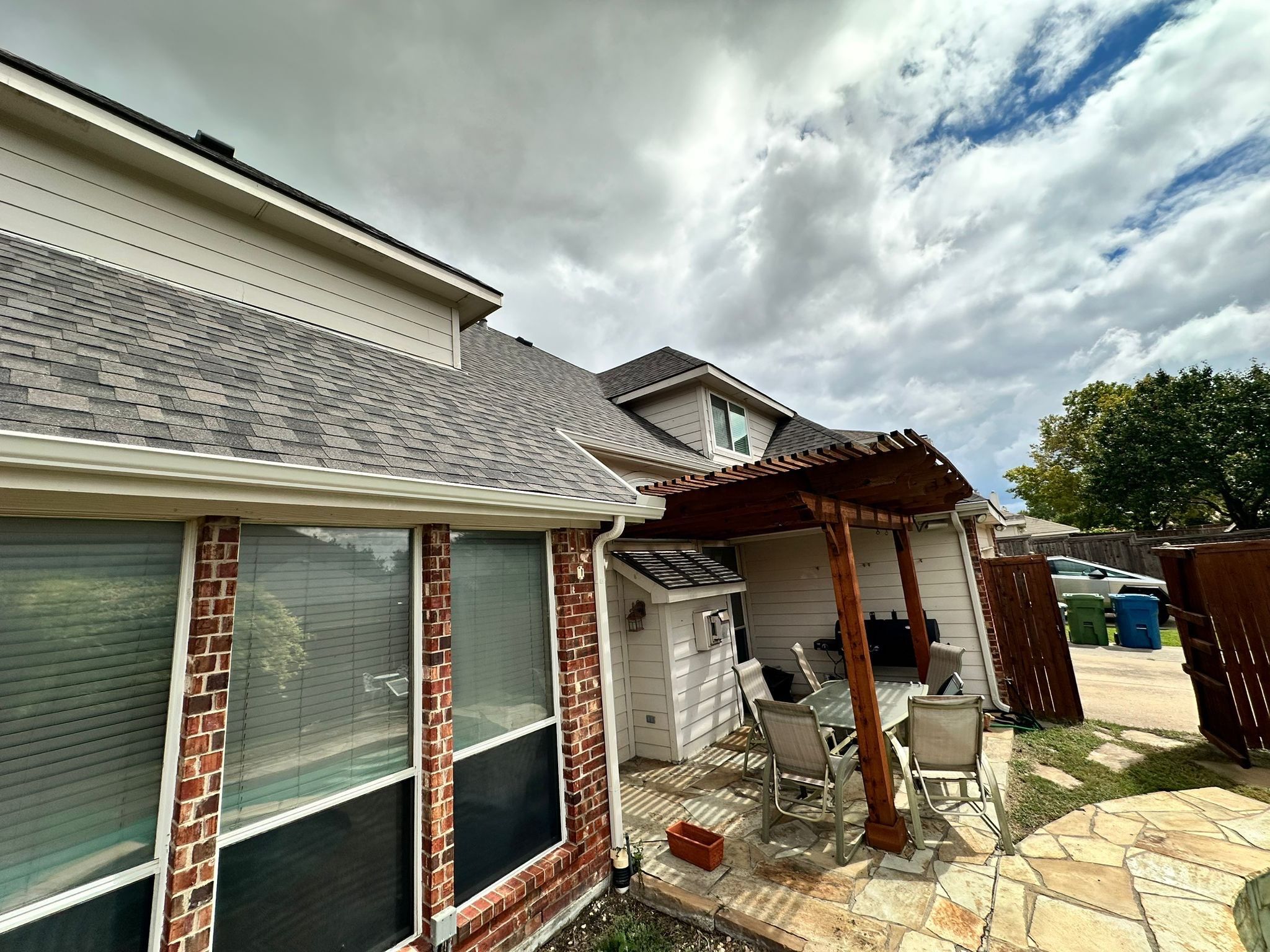 IKO Cornerstone-Dark Reddish Brown brick house  by Tejas Roofworks + Restoration