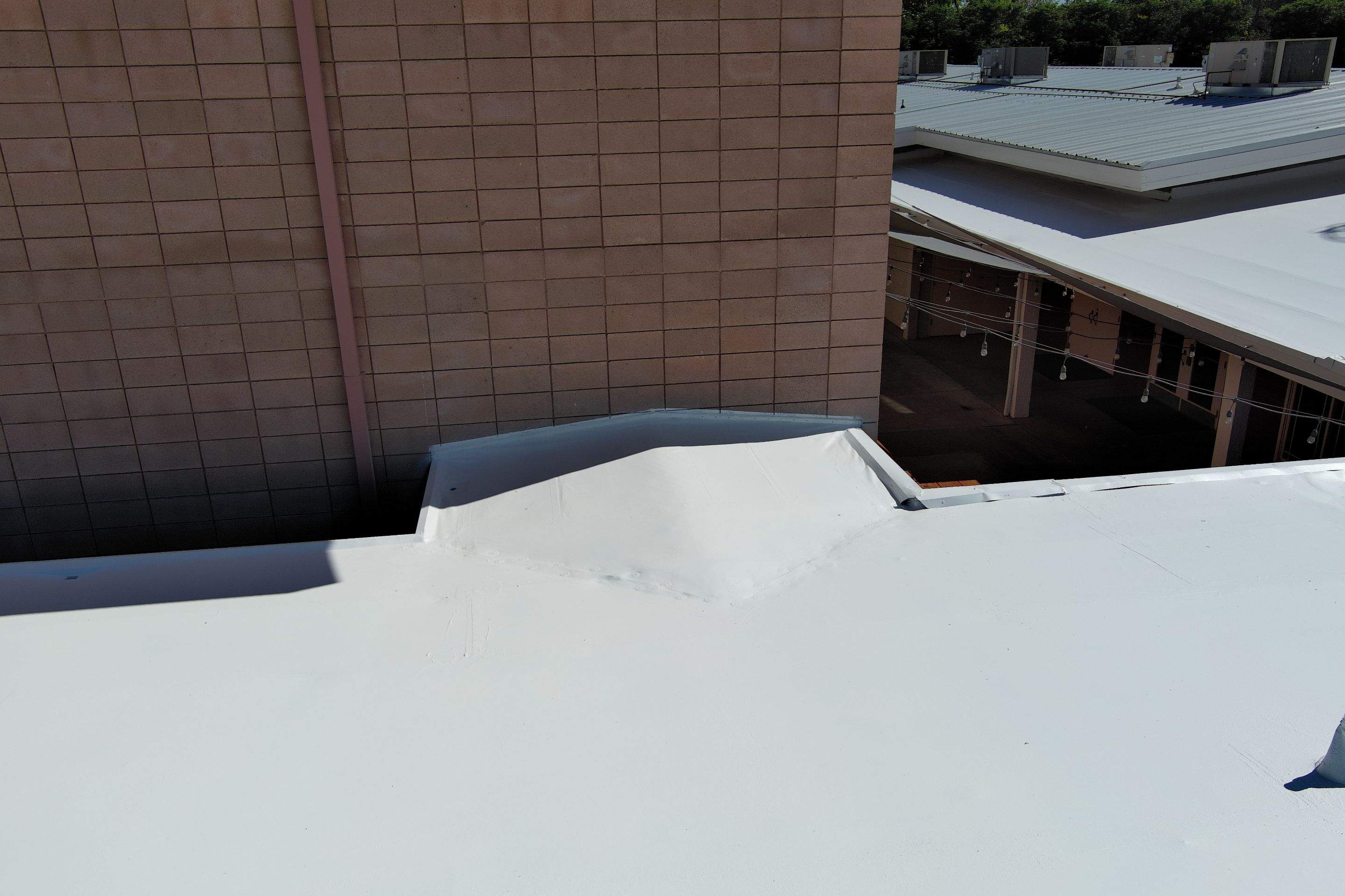 Single-ply restoration system using Benchmark/PUMA XL coatings over TPO single-ply roofing by Straight Edge Roofing Inc