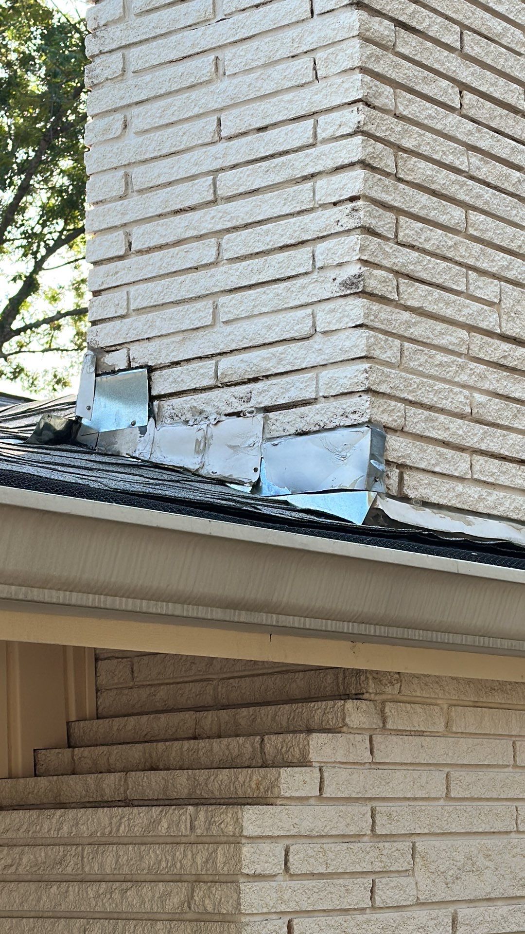 White siding/white brick chimney with Malarkey Silverwood by Tejas Roofworks + Restoration