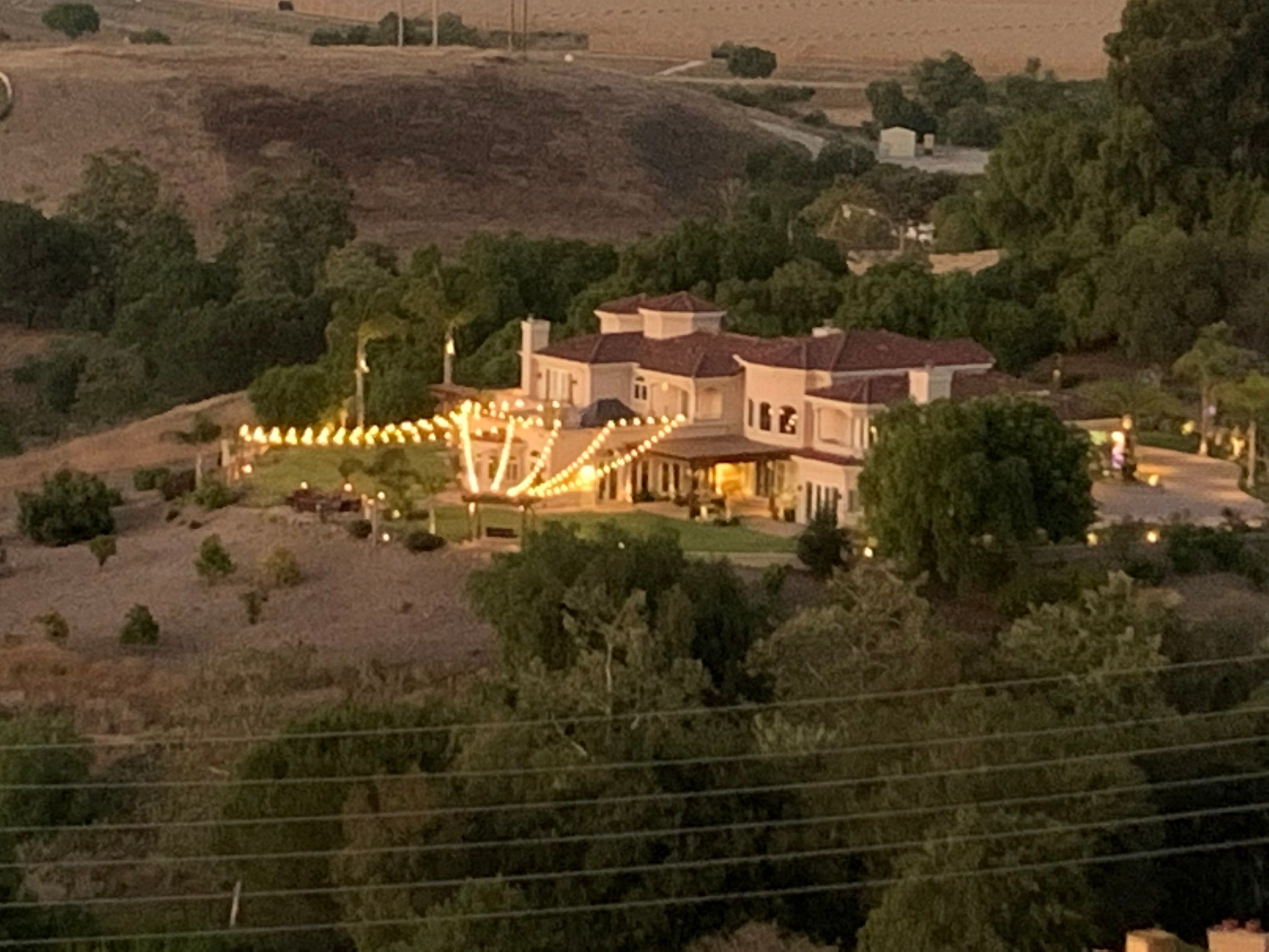 Malibu Hillside Outdoor Living Space with Custom Landscape Lighting + Surround Sound System by Outdoor Lights + Shades
