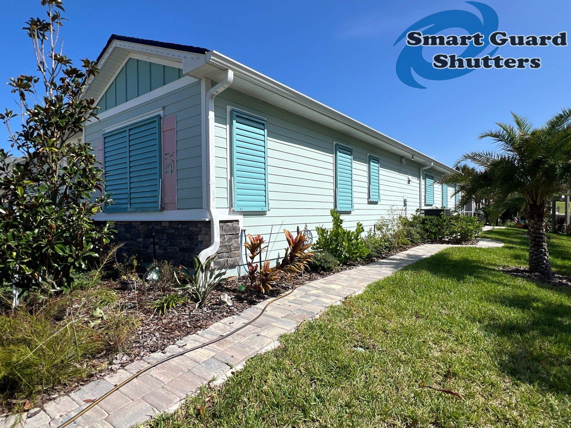 Impact Bahama Shutters in Pastel Turquoise by Smart Guard Shutters