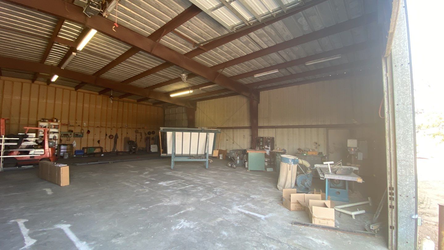 Spray foam insulation on inside of metal industrial building by Straight Edge Roofing Inc
