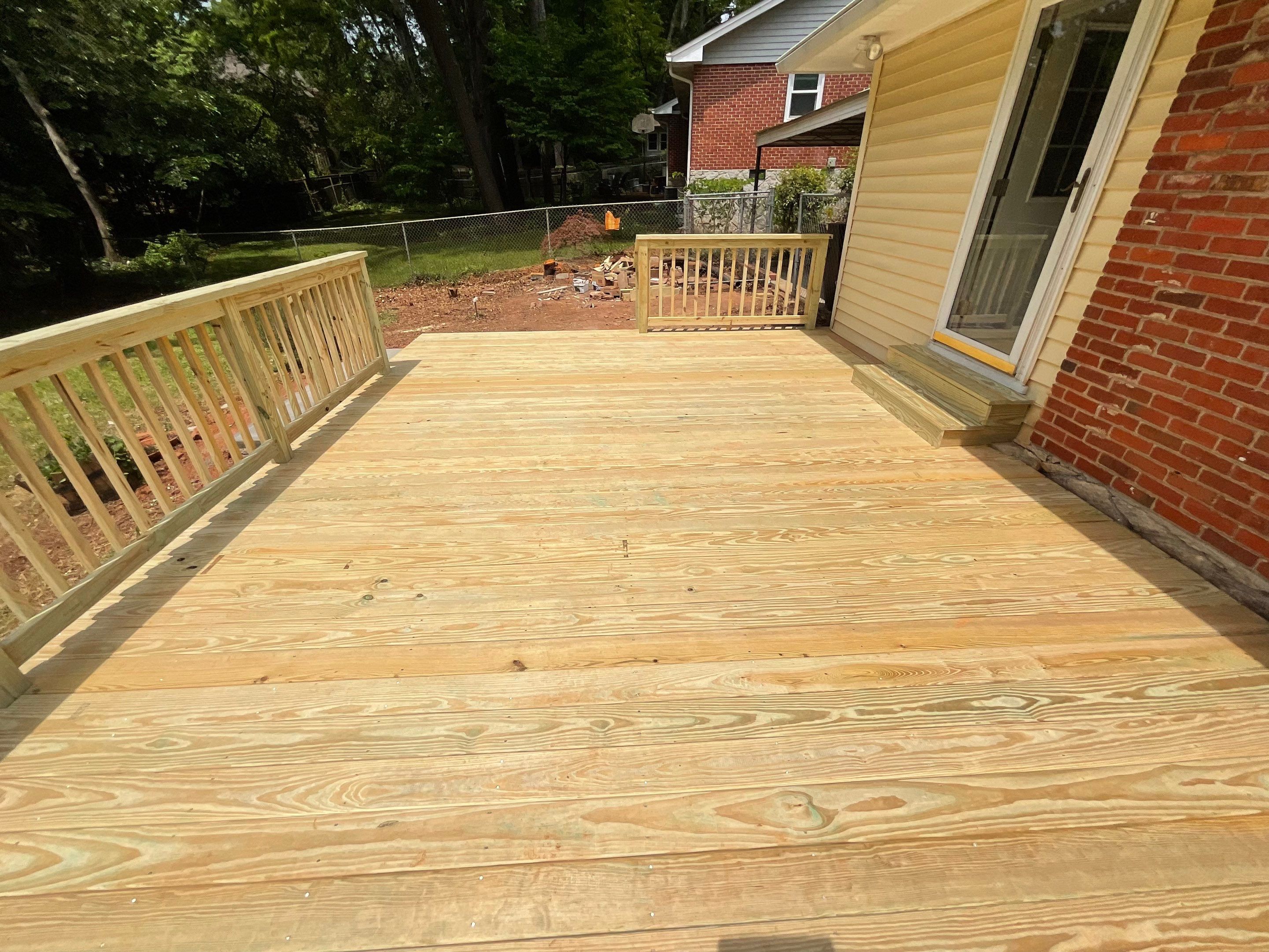 Custom Pressure-Treated Wood Deck and Railing Installation in Decatur by Swift Home Renovations