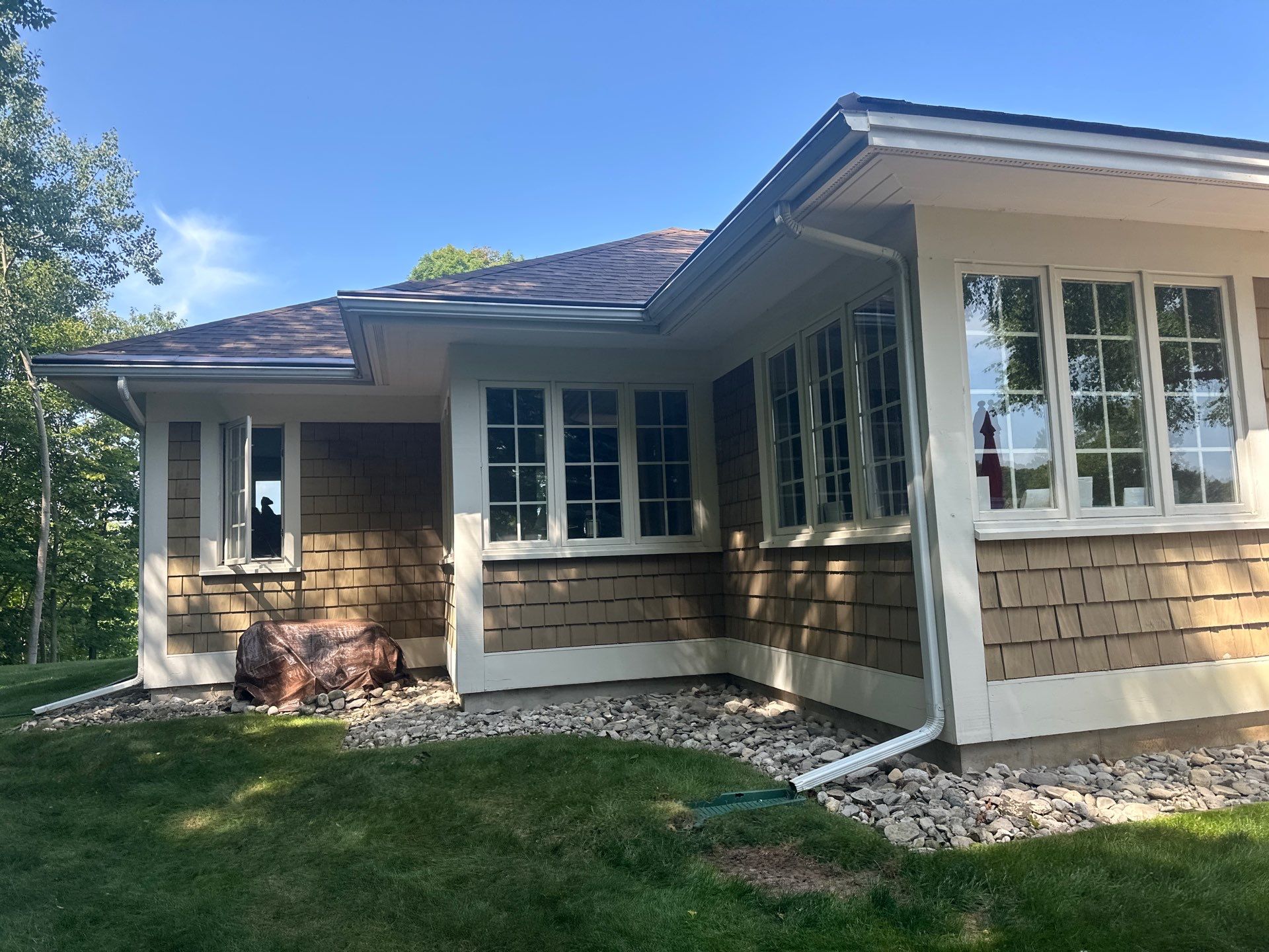 Gutter Helmet Installation for a Traverse City Residence With Shake Siding by Rainbow Seamless Systems