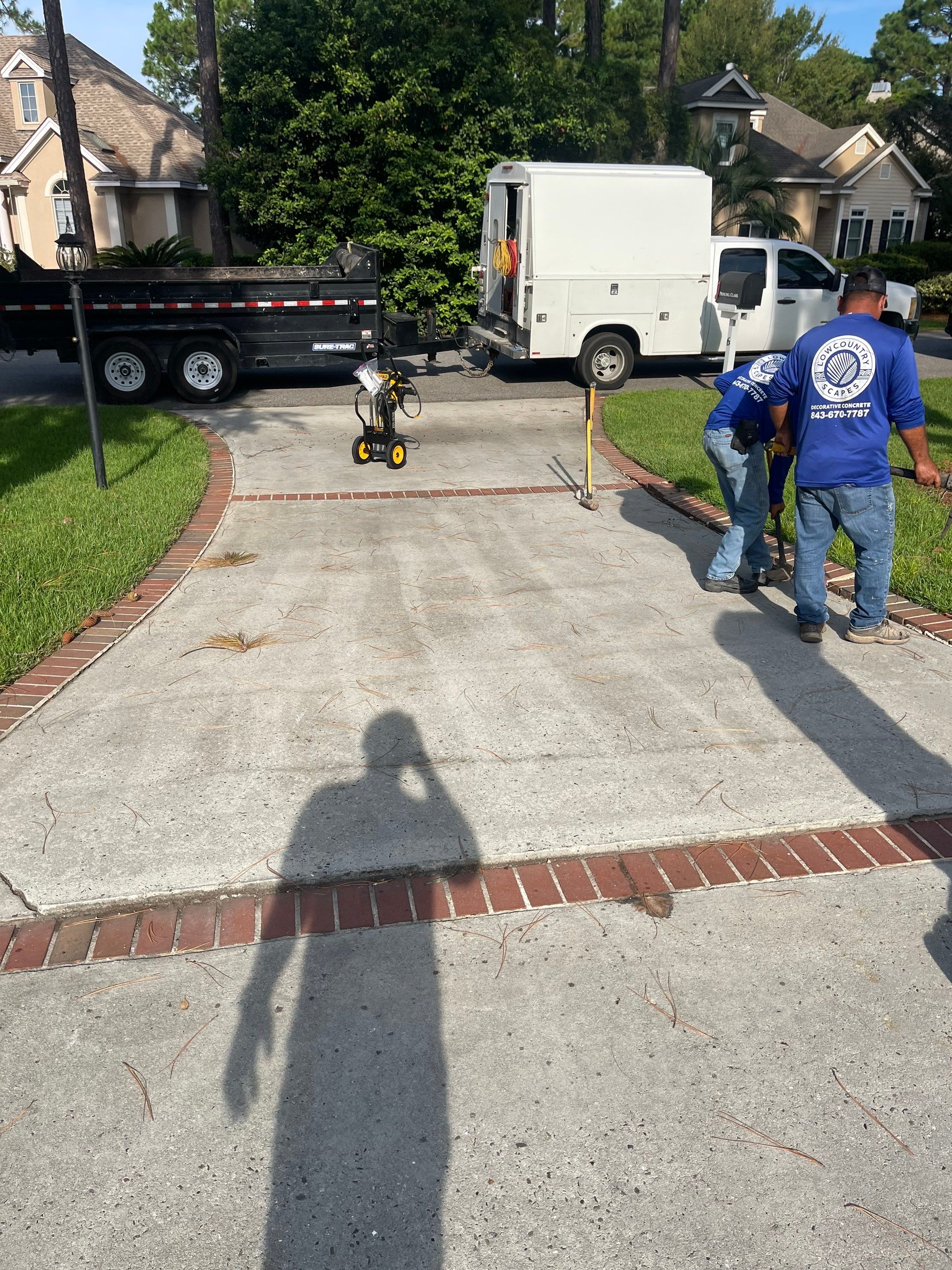 Concrete Driveway Cleaning and Restoration With Decorative Red Brick Border by Lowcountry Scapes, LLC