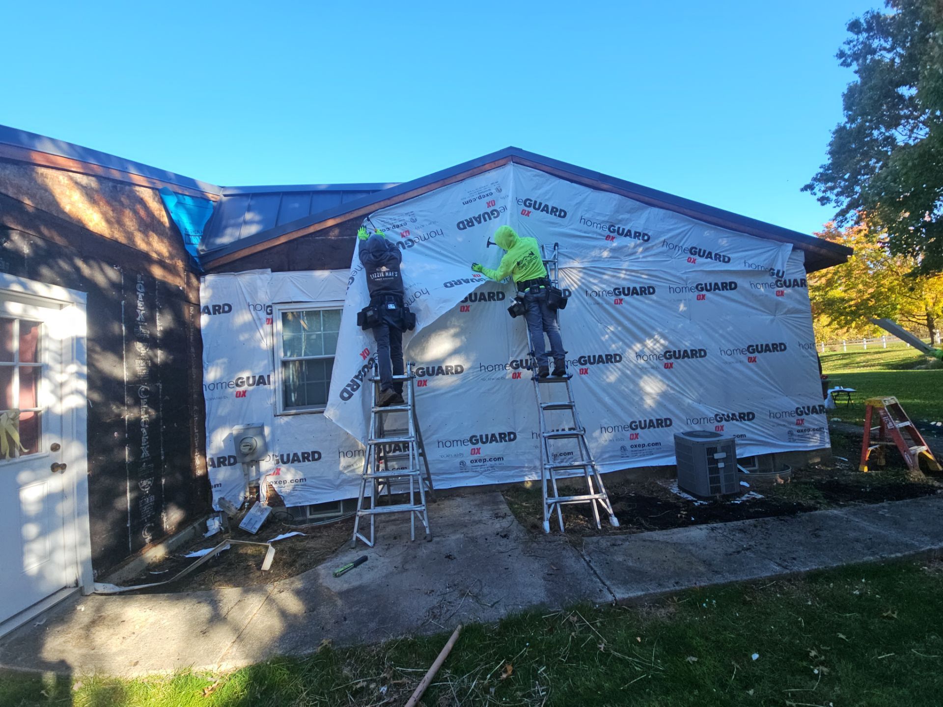 Wadsworth Exterior Transformation Featuring Blue Vertical Siding and Metal Roofing by Cornerstone Roofing And Siding