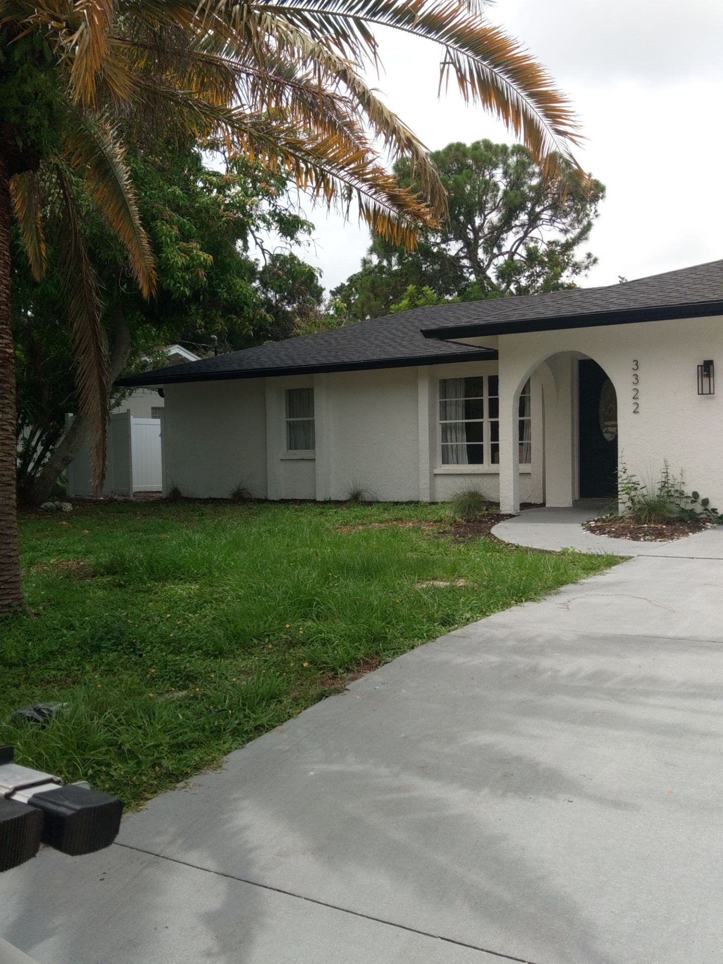 Black seamless gutters and downspouts installation in Sarasota, FL by Gutter Professors