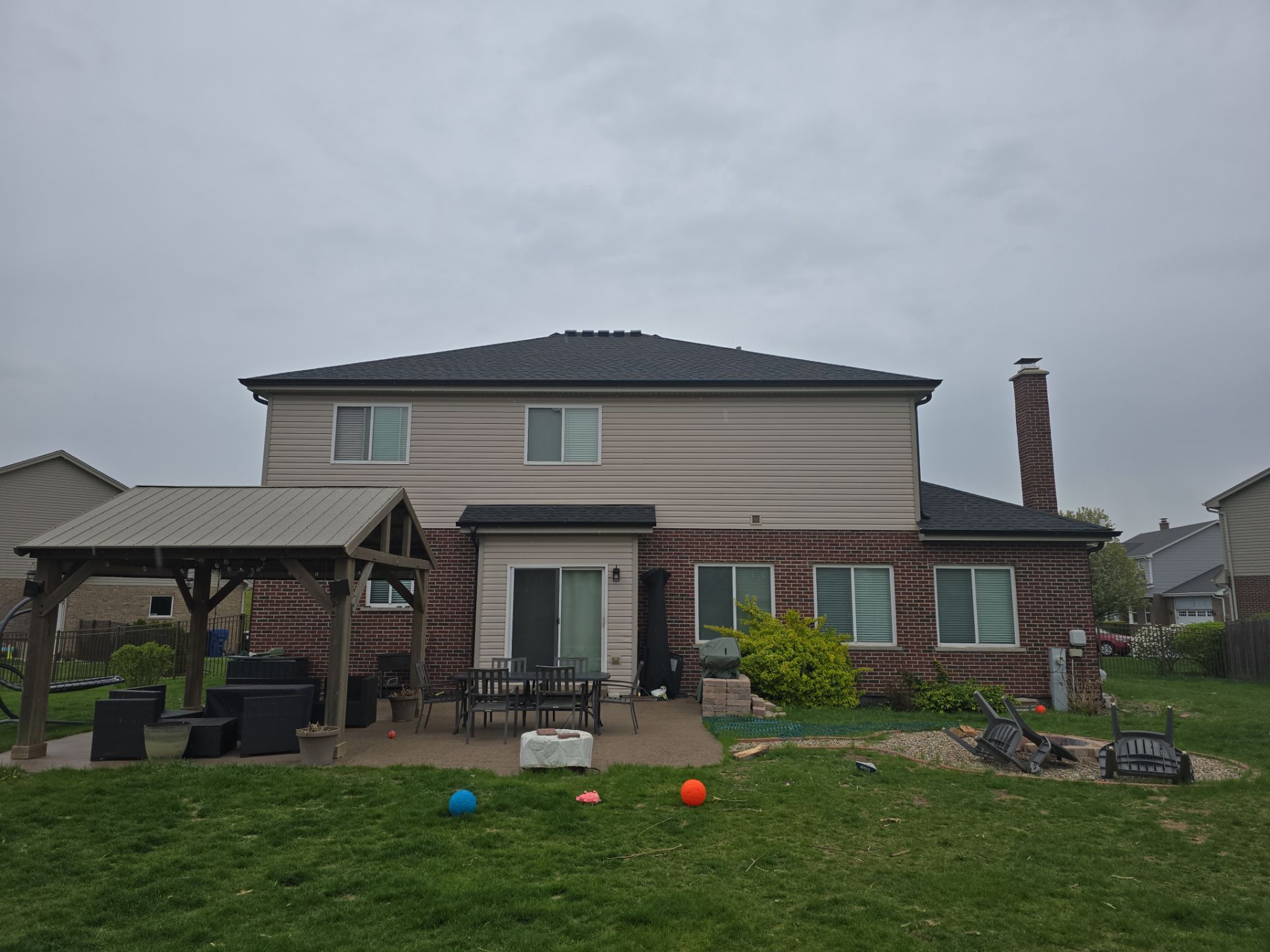 New black gutters and roof by Optimal Home Improvement 