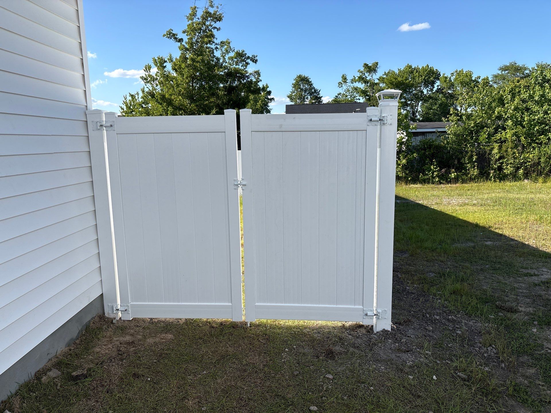 White Hamilton Vinyl Privacy Fence and Double Gate Installation in Greenville by Superior Fence and Rail