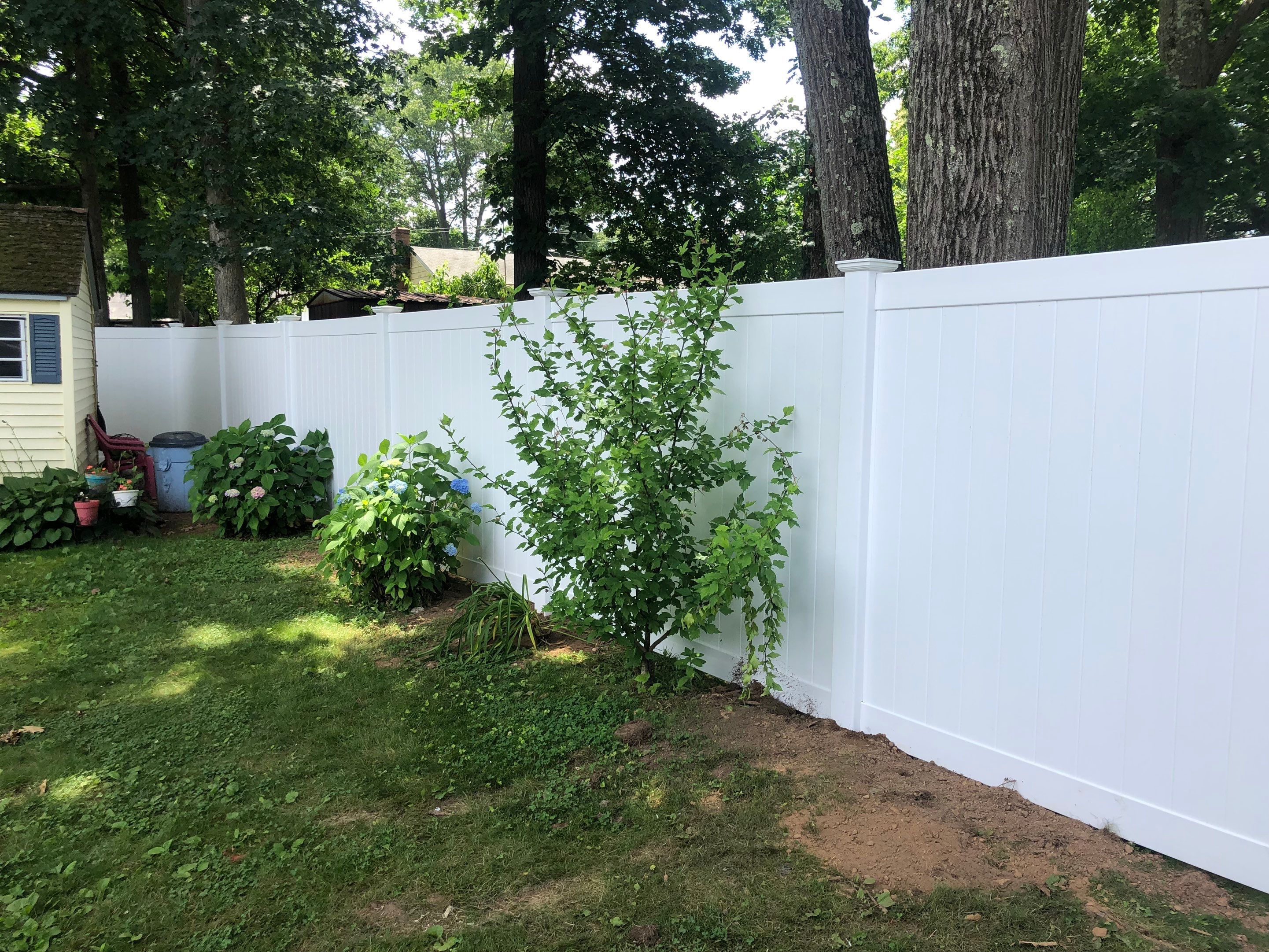 New Vinyl Privacy fence with matching drive gate in white by DiGiorgi Roofing and Siding Inc