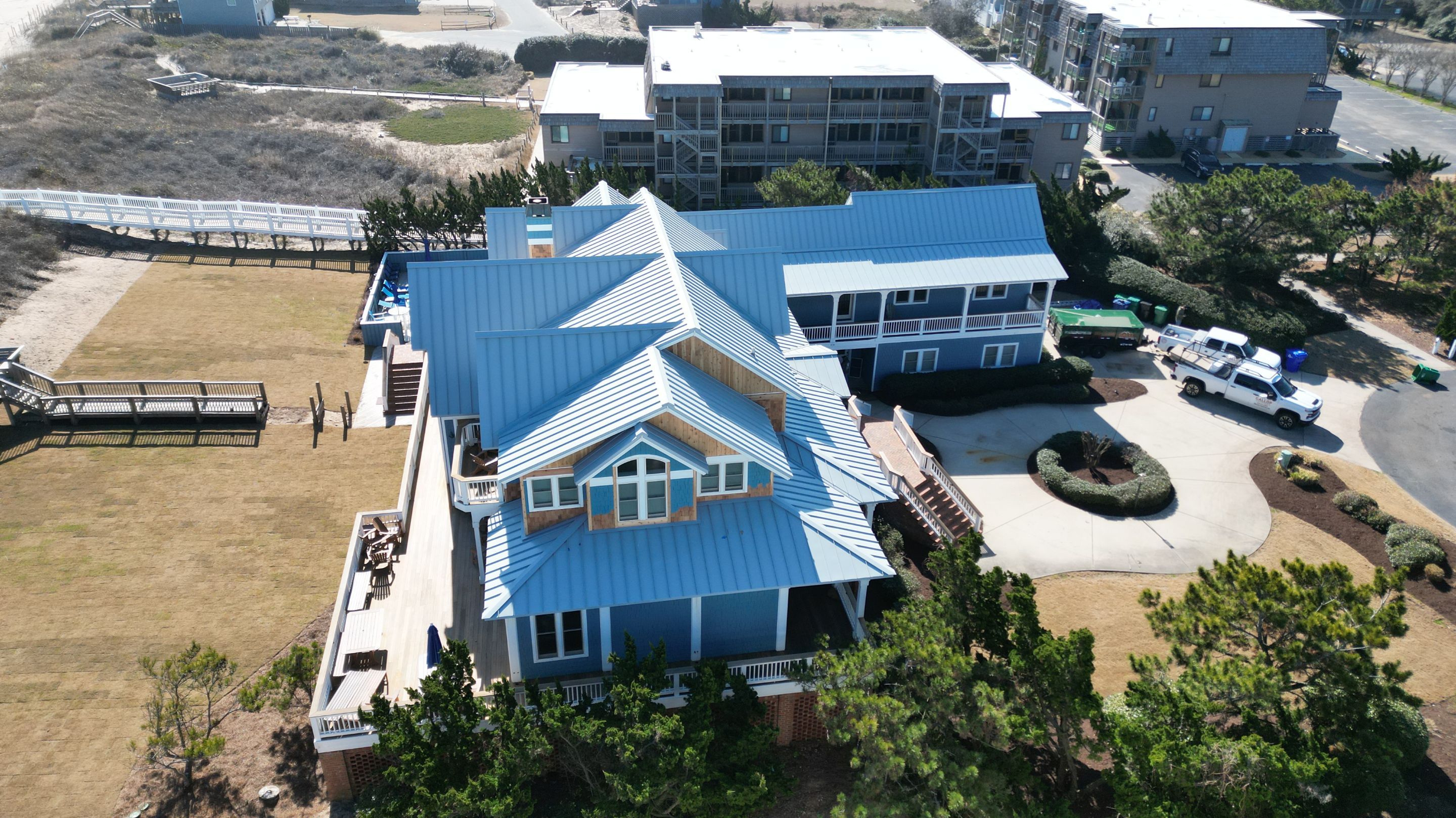 Large Metal Roof Transformation by Gallop Roofing & Remodeling, Inc.