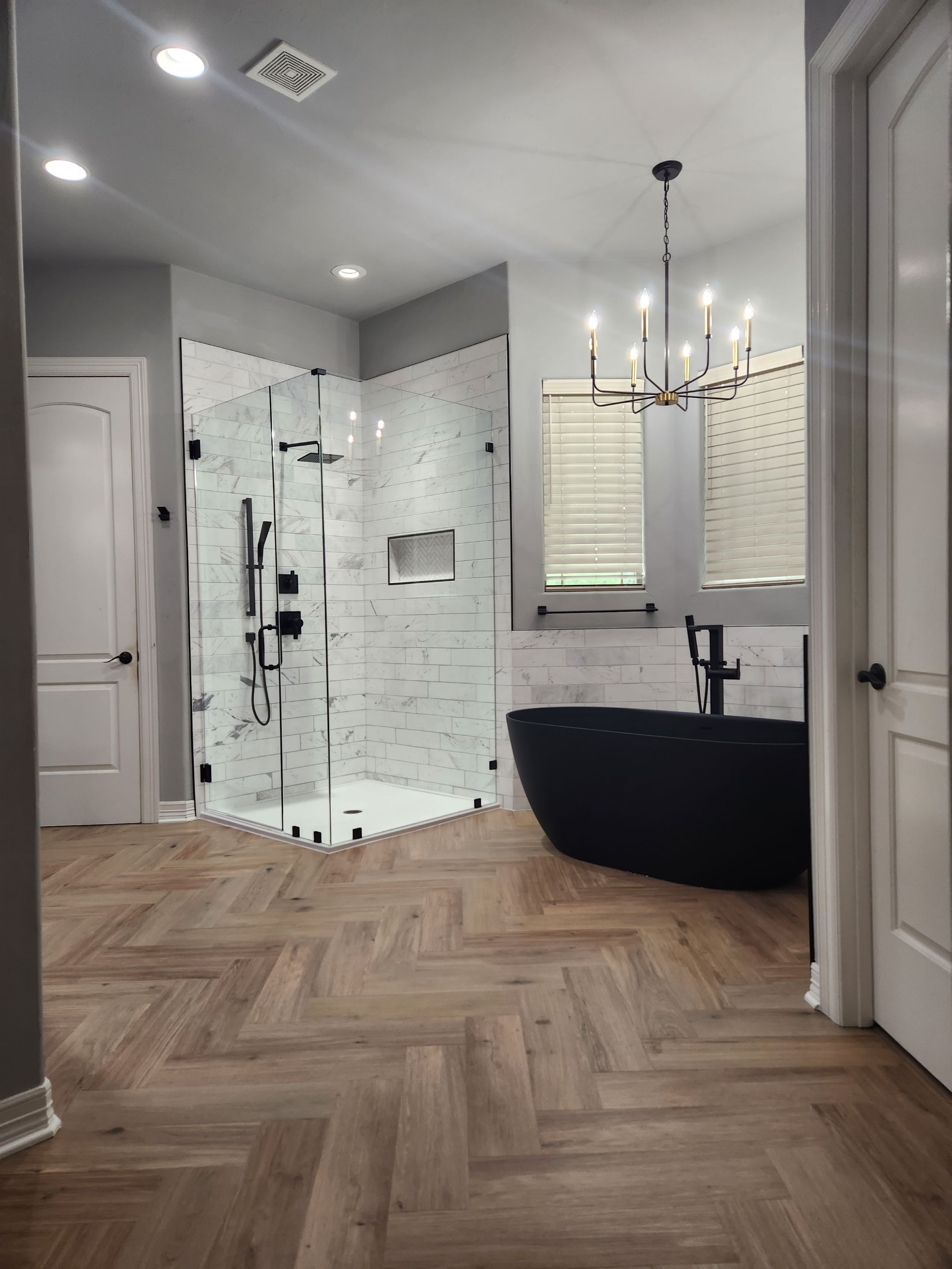 Spring Bathroom Remodel with Black Free-Standing Tub and Walk-In Shower by Legacy Bath and Kitchen