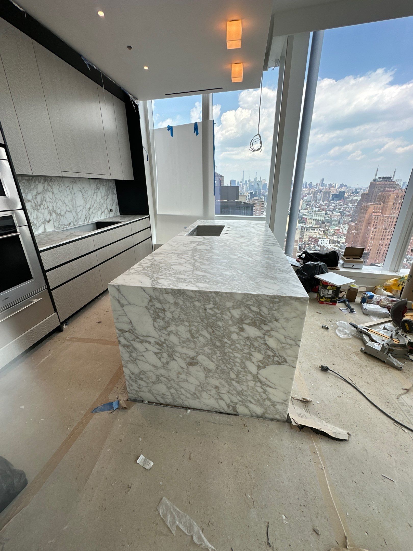 Kitchen Countertop with backsplash and Island top with mitered waterfalls by NC Stone And Tiles