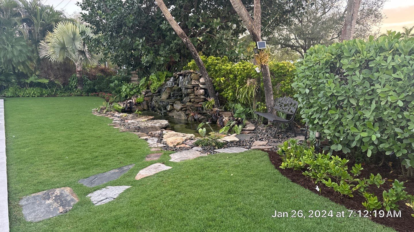 A Beautiful Relaxing Koi Pond with Waterfall in Pinecrest by Nature's Dream Landscape and Tree Service