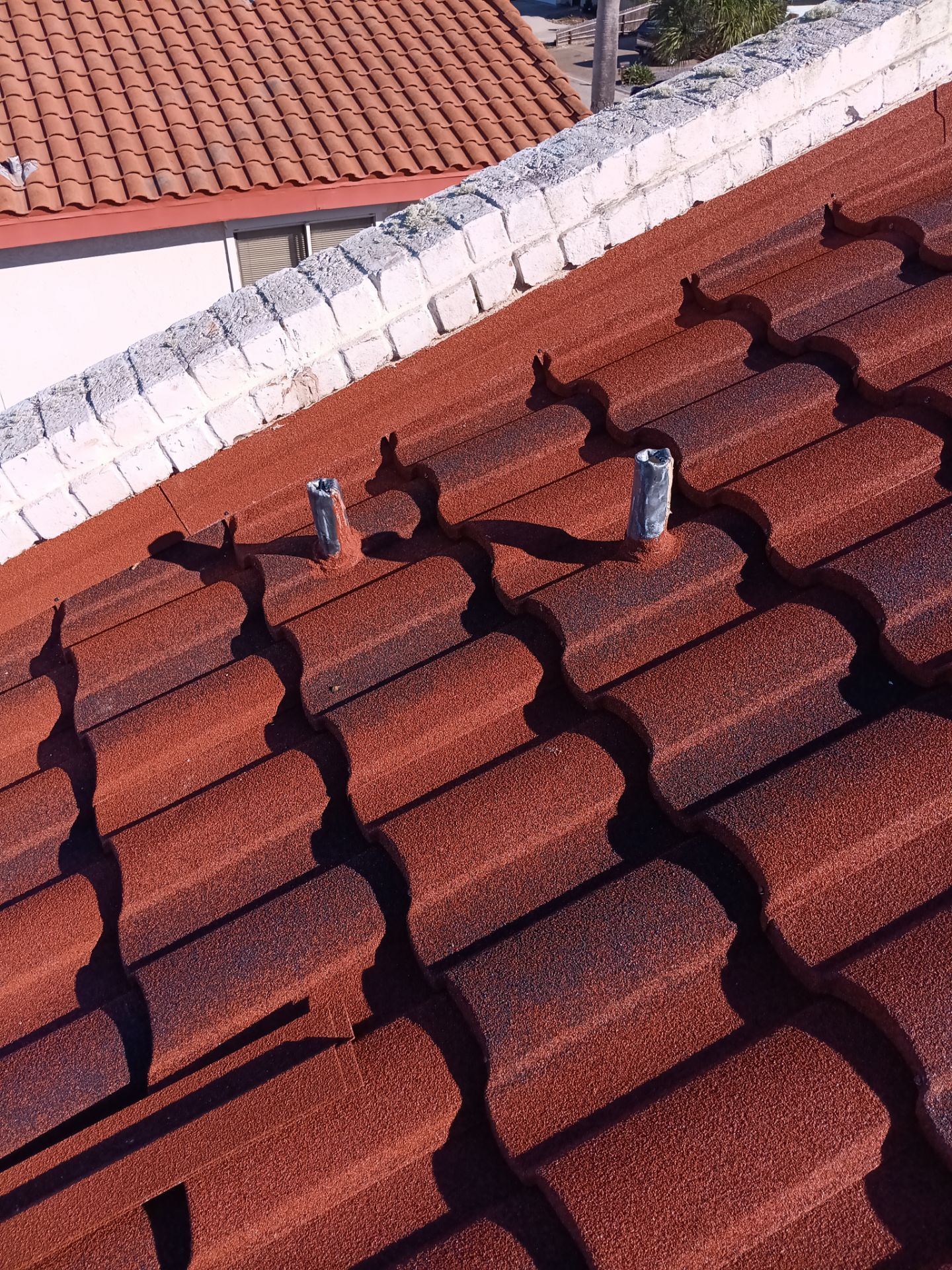 Off with the Tile and on with the TILCOR stone coated metal.  by Bayfront Roofing and Construction