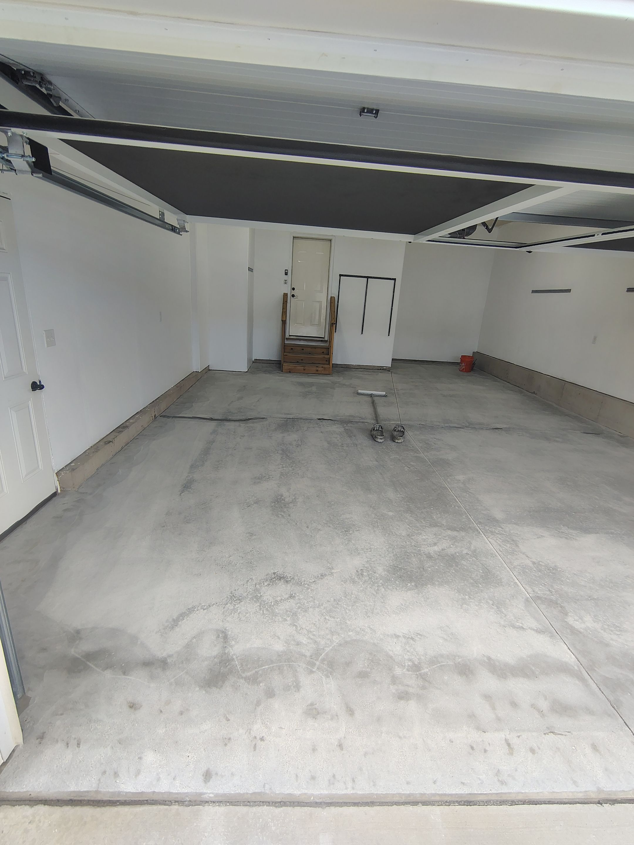 Sioux Falls Garage Floor Transformation With Gray Speckled Epoxy Coating by Select Painting, Coatings & Garage Cabinets