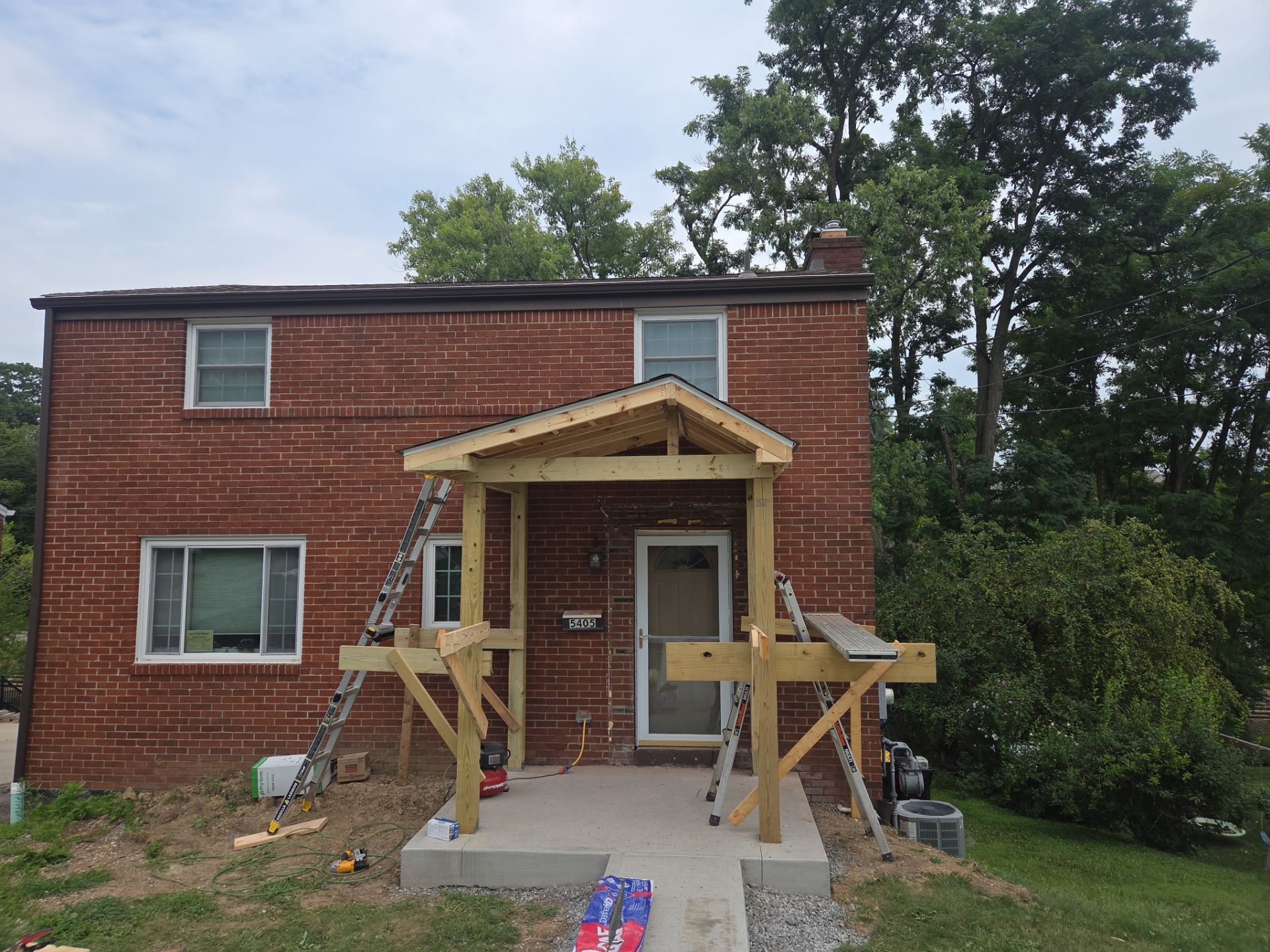 Concret and roof build  by Cousins Roofing Siding & Decks