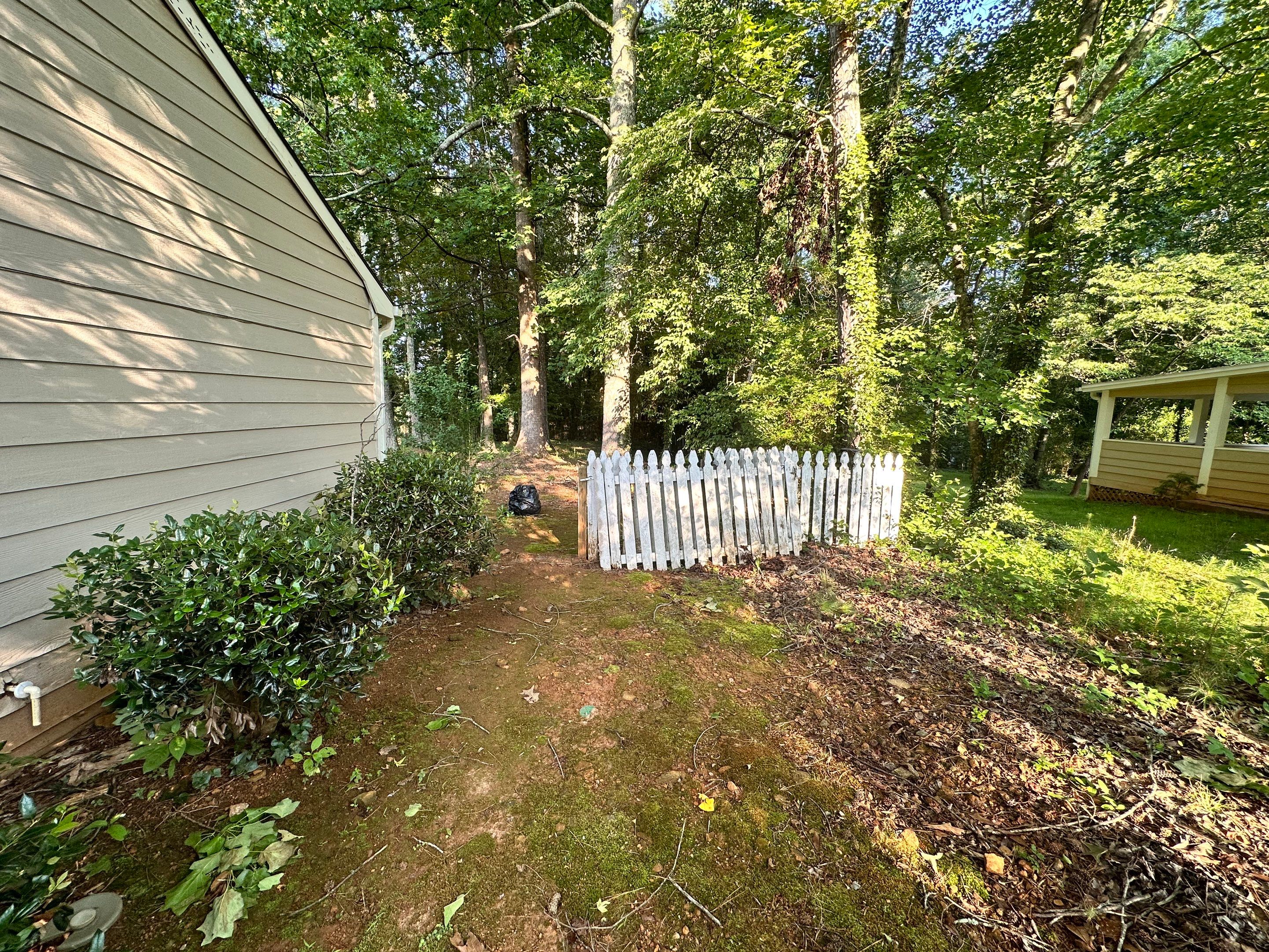 Exterior Siding Painting and Picket Fence Installation in Powder Springs by Swift Home Renovations