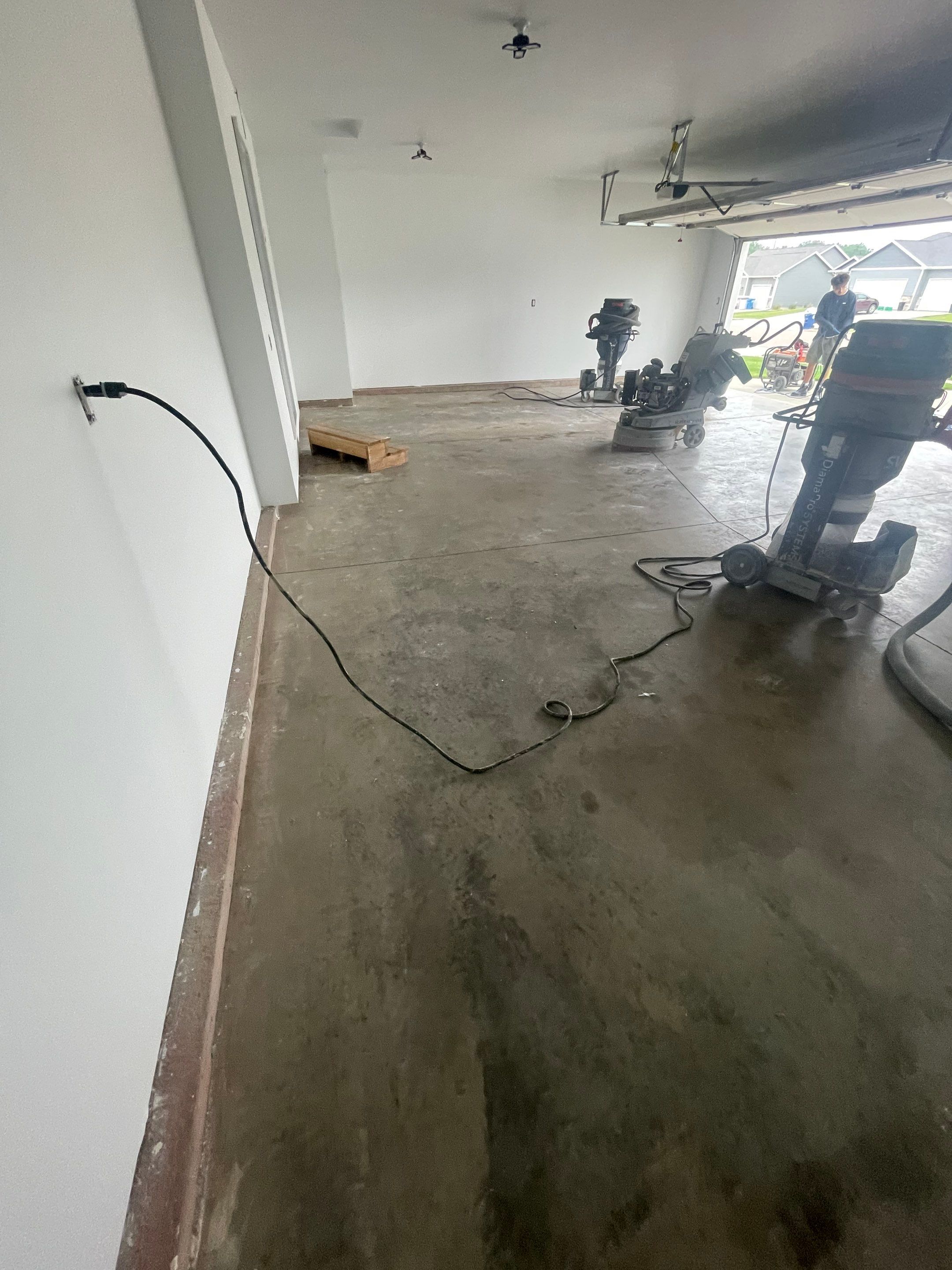 Grey Flake Epoxy Garage Floor Coating in Sioux Falls by Select Painting, Coatings & Garage Cabinets