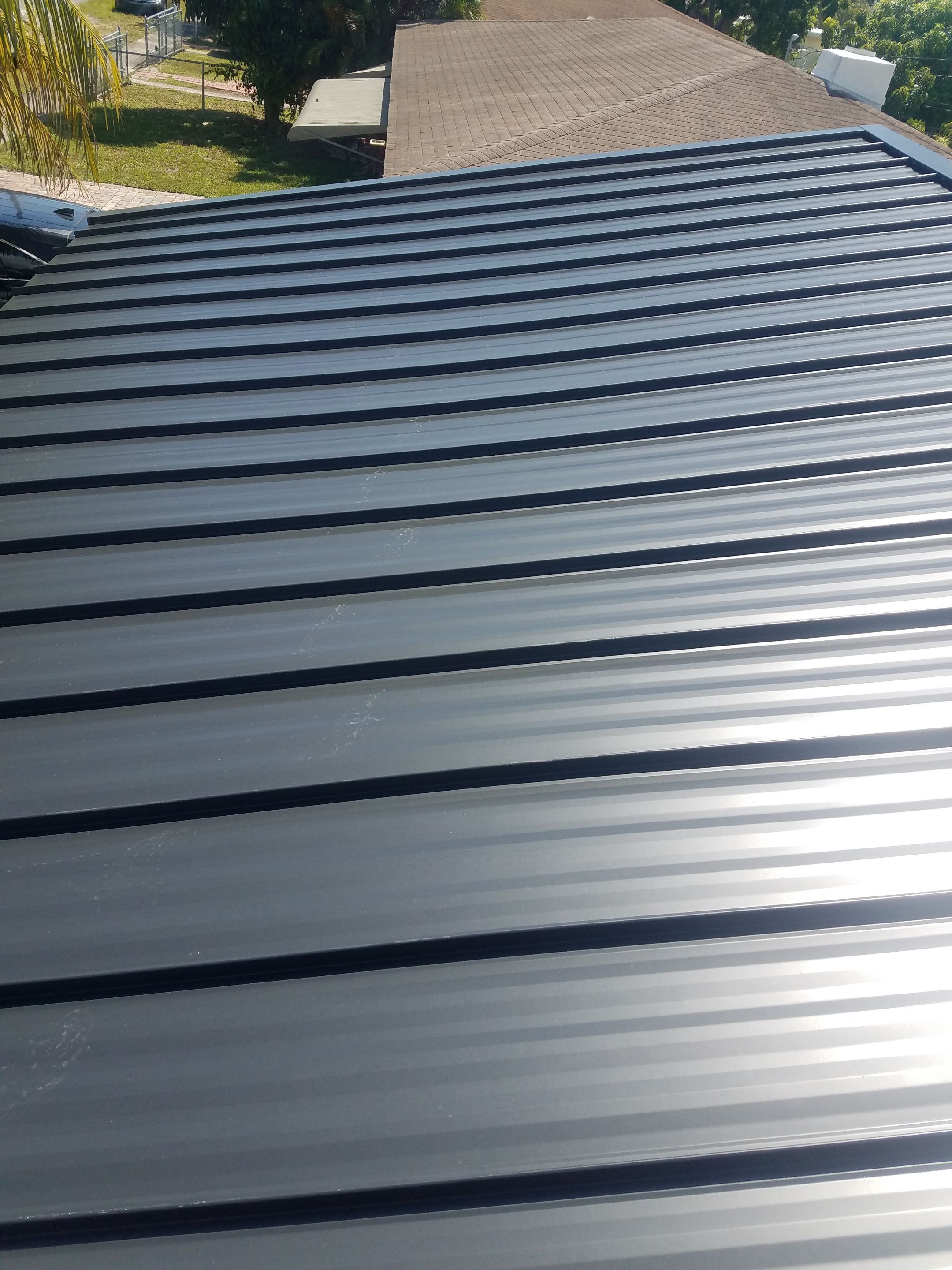 Standing Seam Metal & Flat Re-Roof using 1.5" Nail Strip 24ga Black Matte Kynar Coated Standing Seam Metal Panels by Morton Roofing, Inc.
