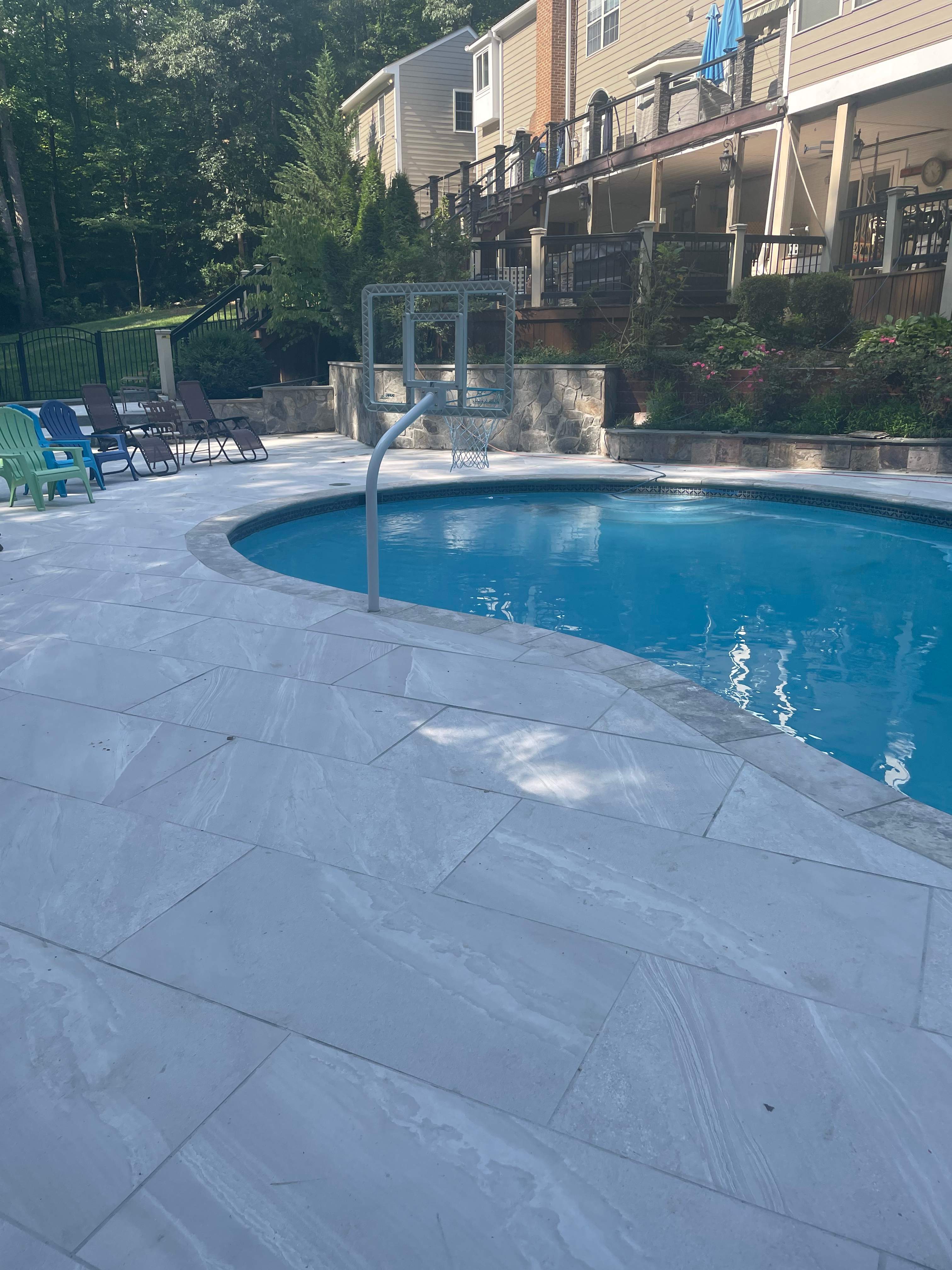 Pool Surround remodel with retaining walls, new waterfall and water slide by Fairfax Contractors, LLC