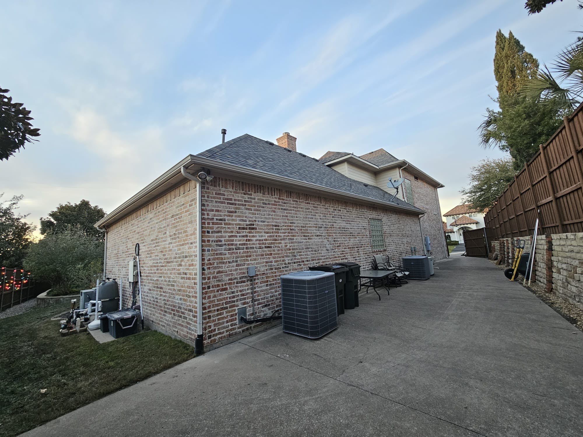 Light red brick/cream stone/espresso shutters with IKO Cornerstone by Tejas Roofworks + Restoration