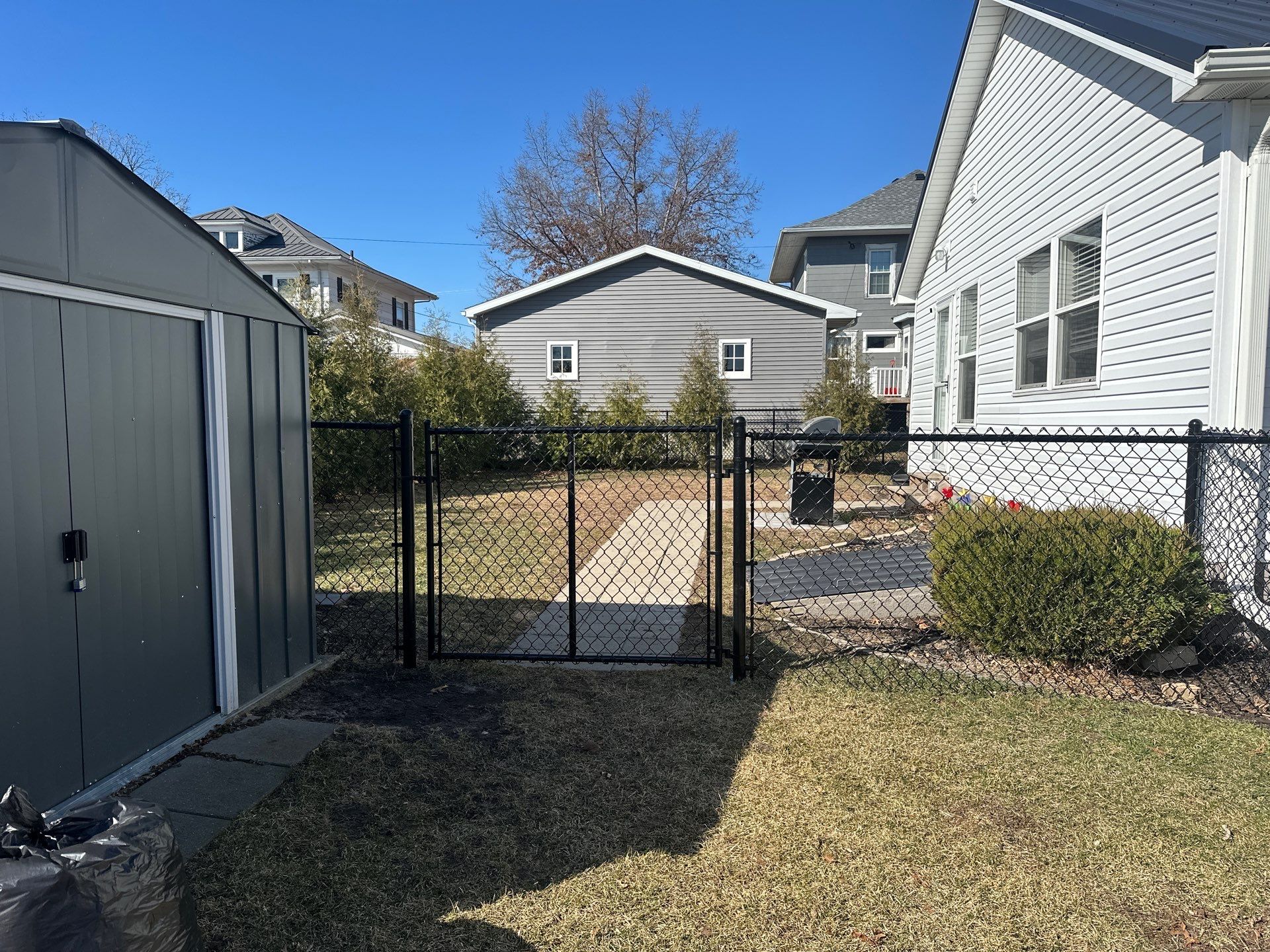 Black Chain Link Backyard Fence Installation in Independence by Perfect Picket Fence and Stain